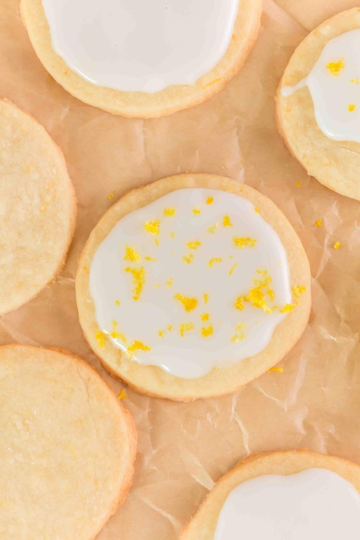 Λεμονάτα μπισκότα shortbread με μια υποψία ξύσματος ξεκουράζονται κομψά σε αντικολλητικό χαρτί.