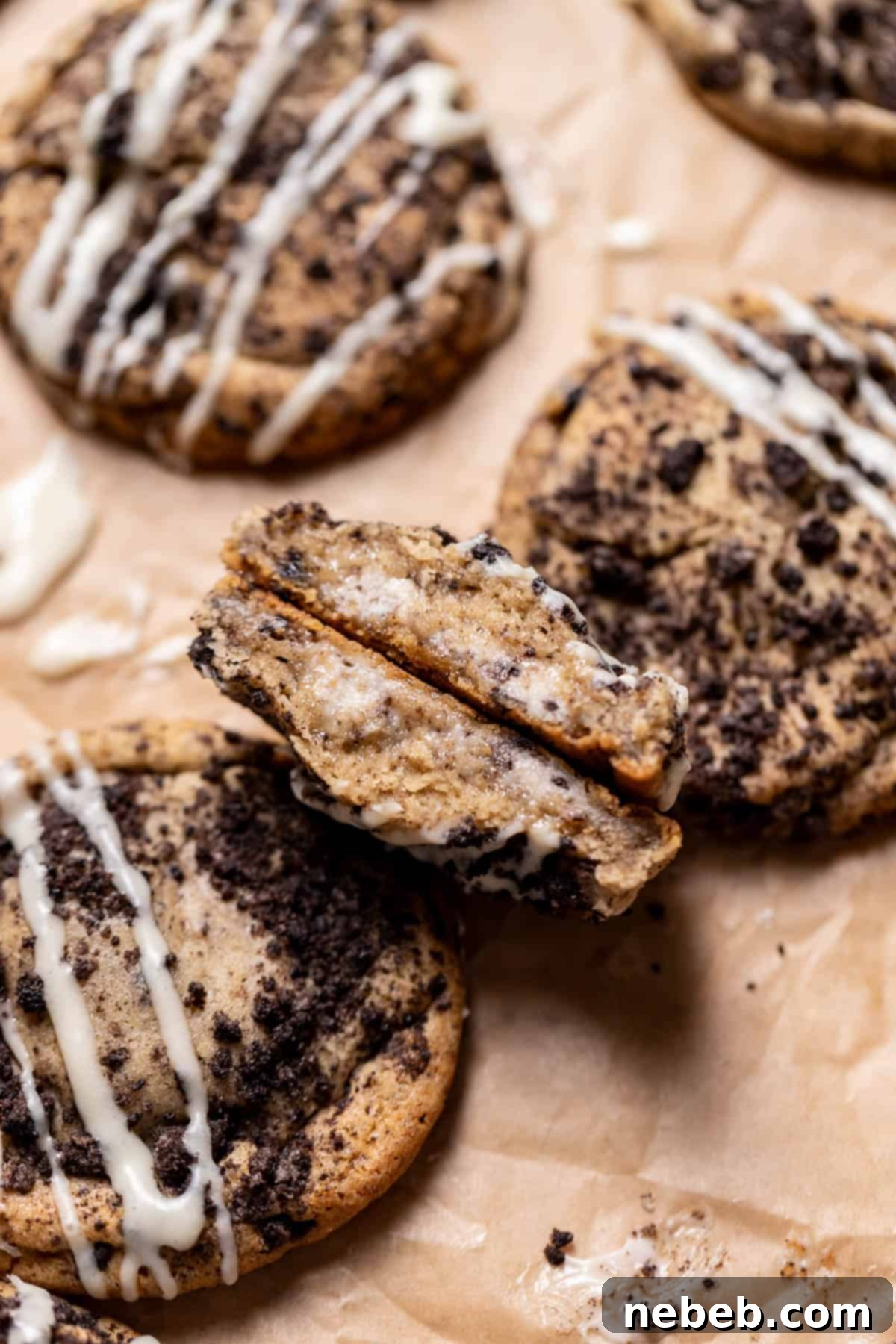 Oreo cheesecake cookie cut in half to show the creamy cheesecake filling.