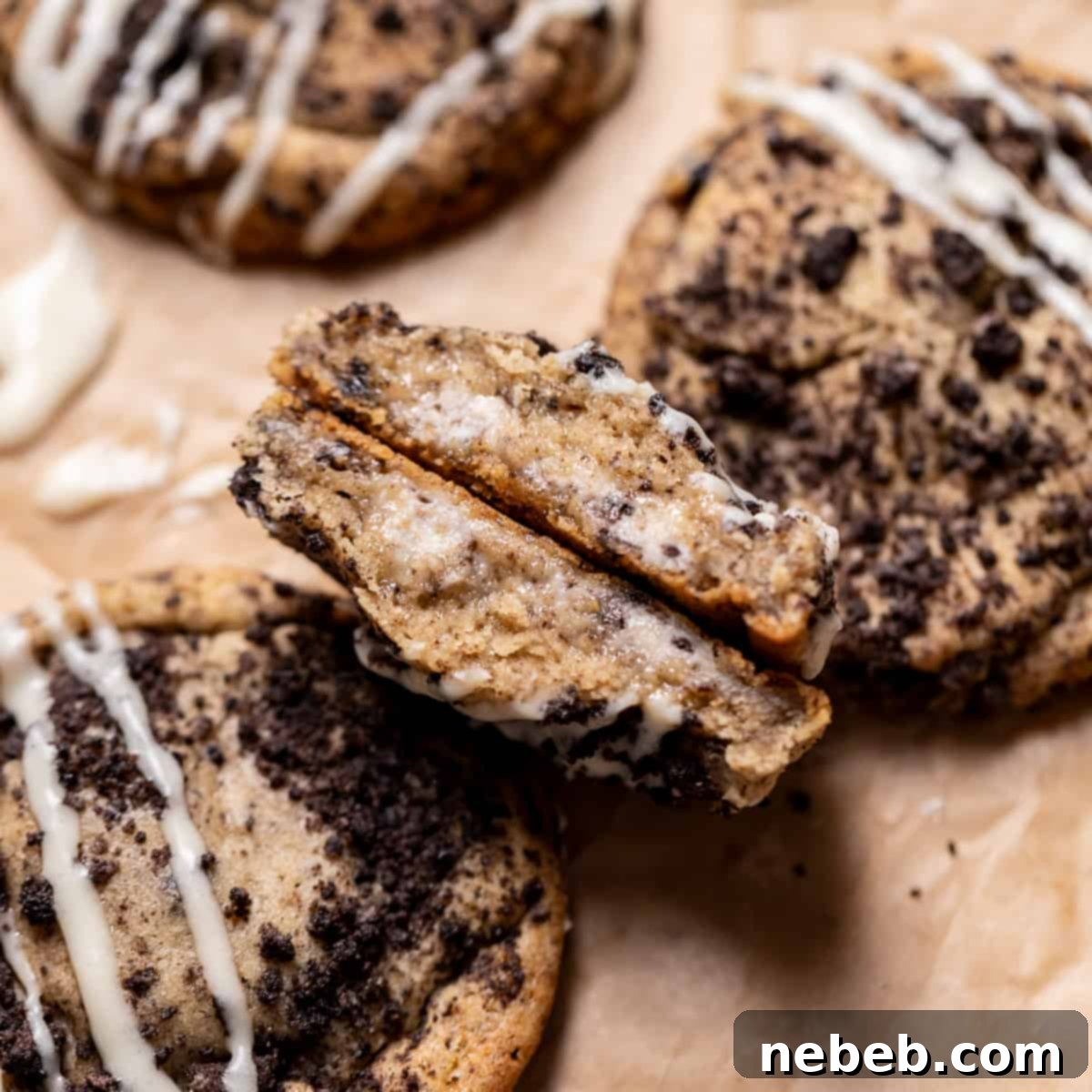 Oreo cheesecake cookie cut in half to show the creamy cheesecake center.