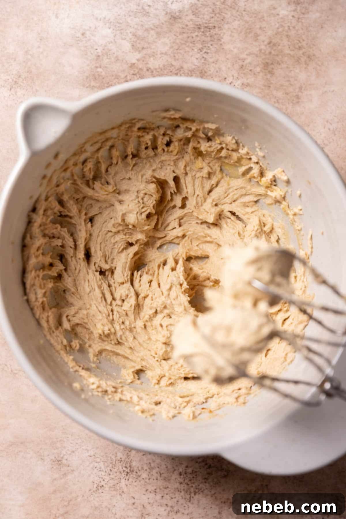 Creamed butter, sugar, and eggs in a mixing bowl after mixing wet ingredients.