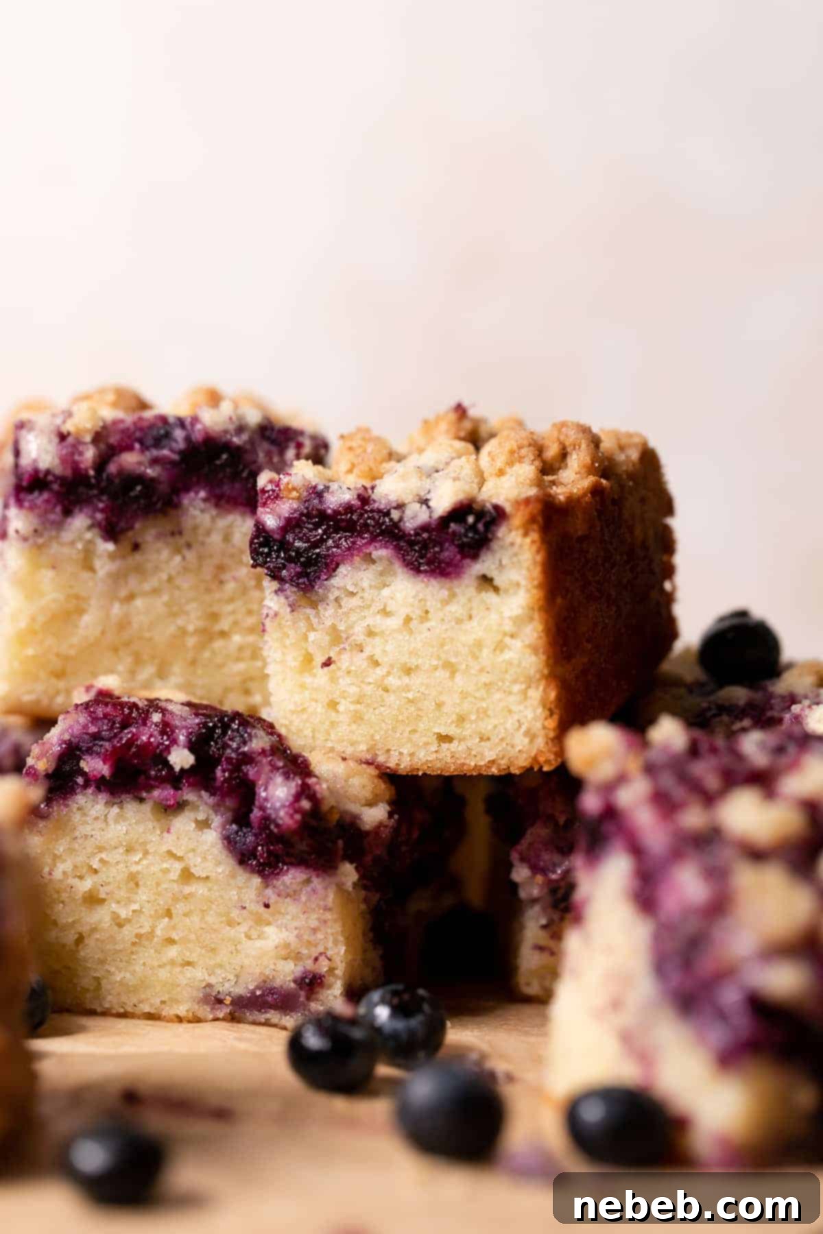 stacked slices of baked blueberry crumble cake with a fluffy texture, ready to serve.