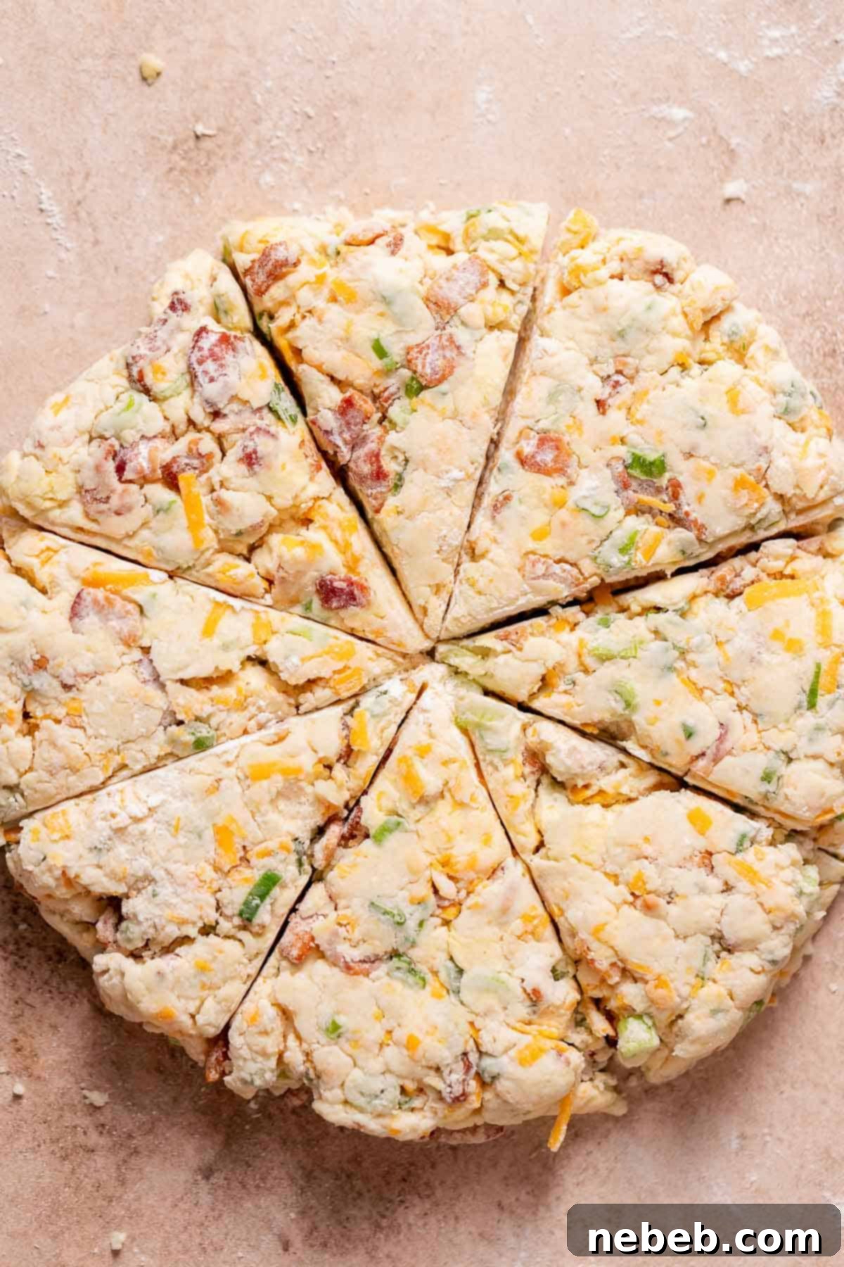 An overhead shot of the scone dough cut into 8 triangles.