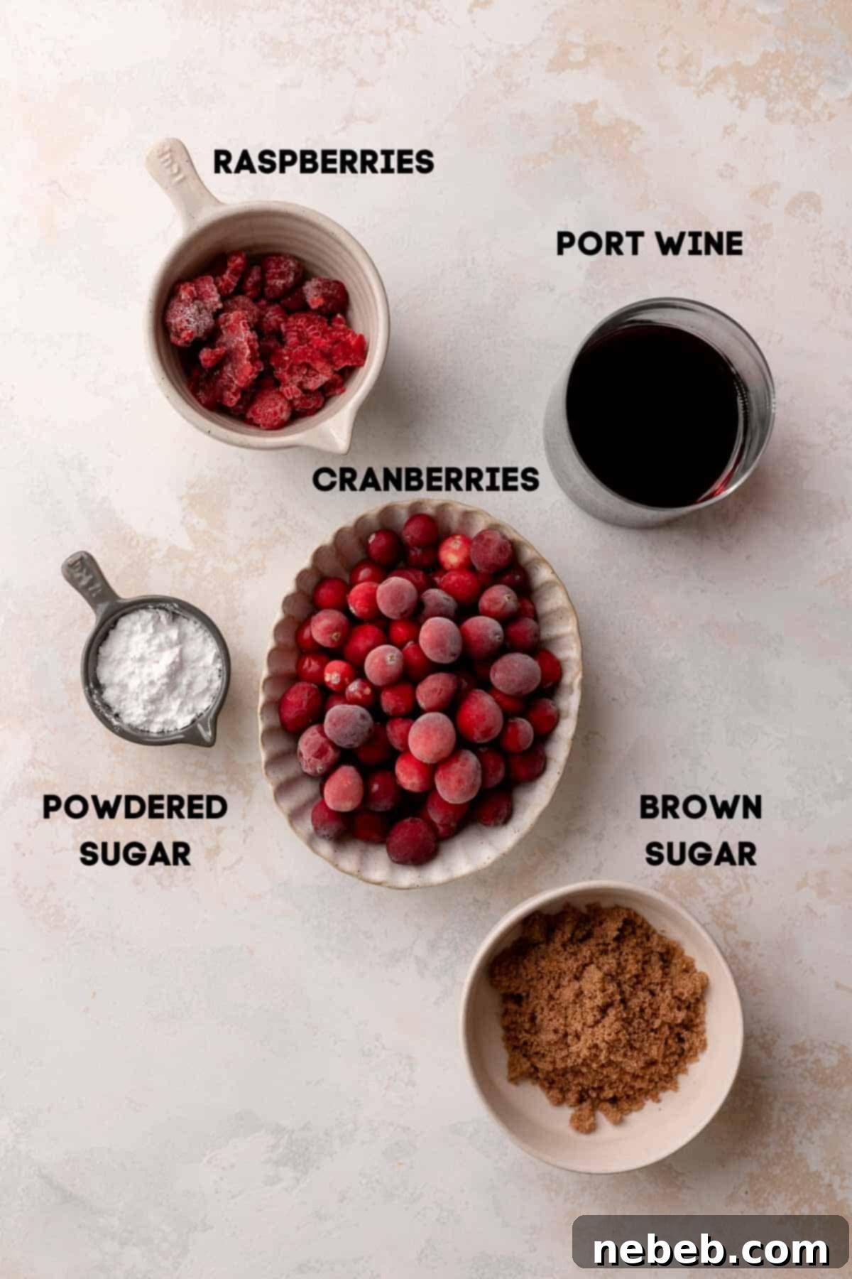 Bowls of fresh and frozen cranberries, raspberries, port wine, and brown sugar – the vibrant ingredients for the homemade jam filling.