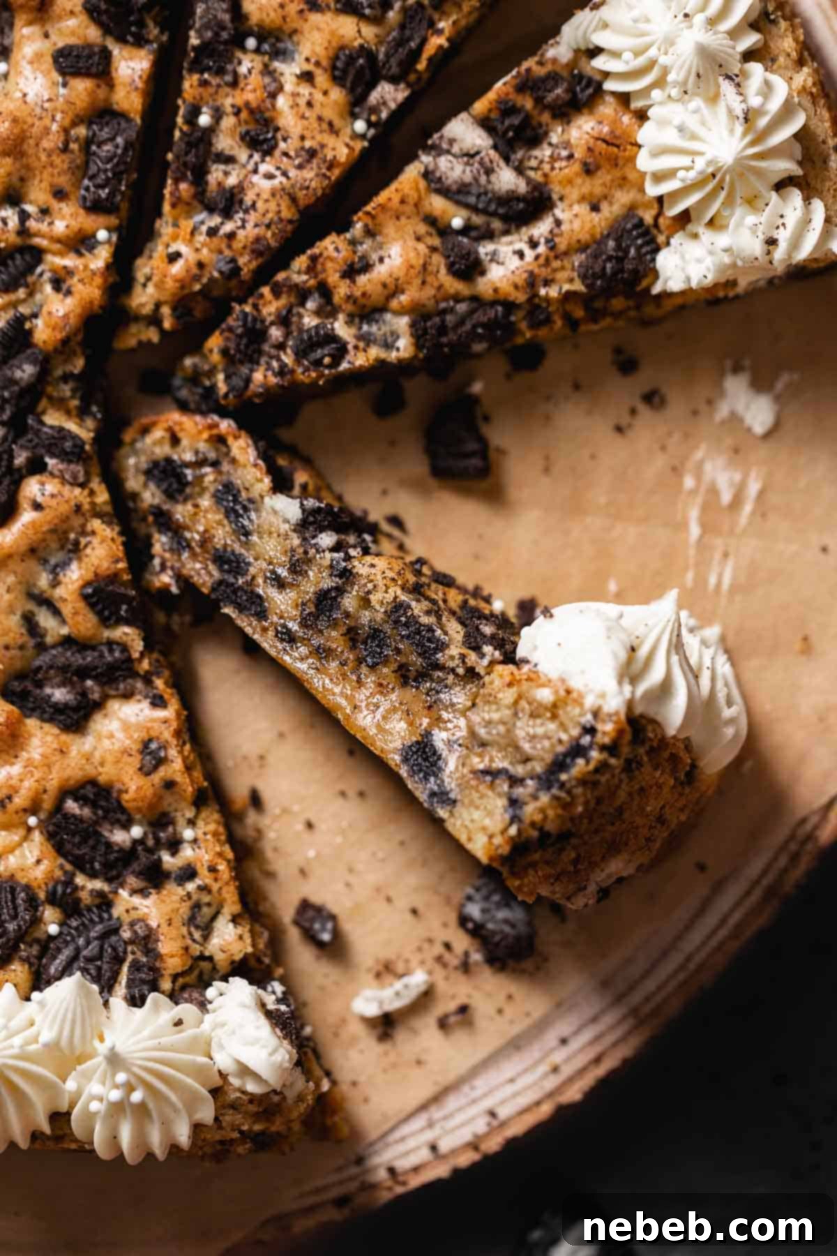 Slices of oreo cookie cake with vanilla frosting piped on top.