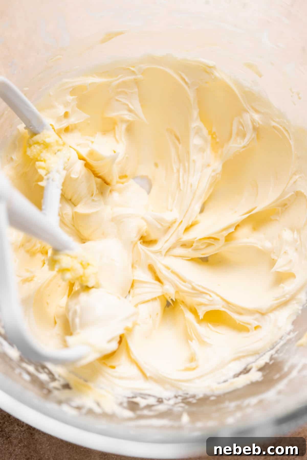 A mixing bowl with the vanilla buttercream frosting in it.