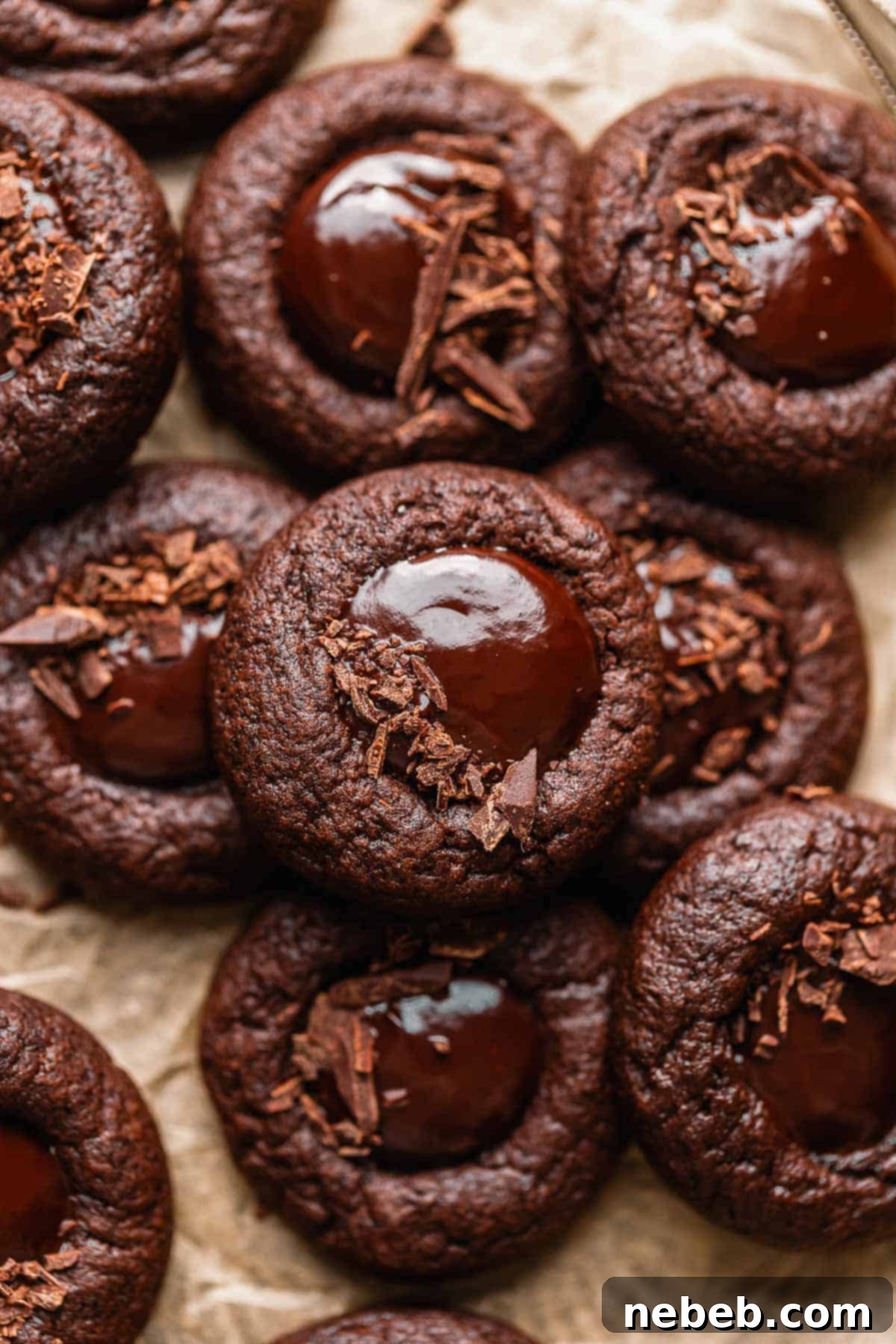 Chocolate thumbprint cookies filled with glossy chocolate ganache and lightly sprinkled with finely chopped chocolate.