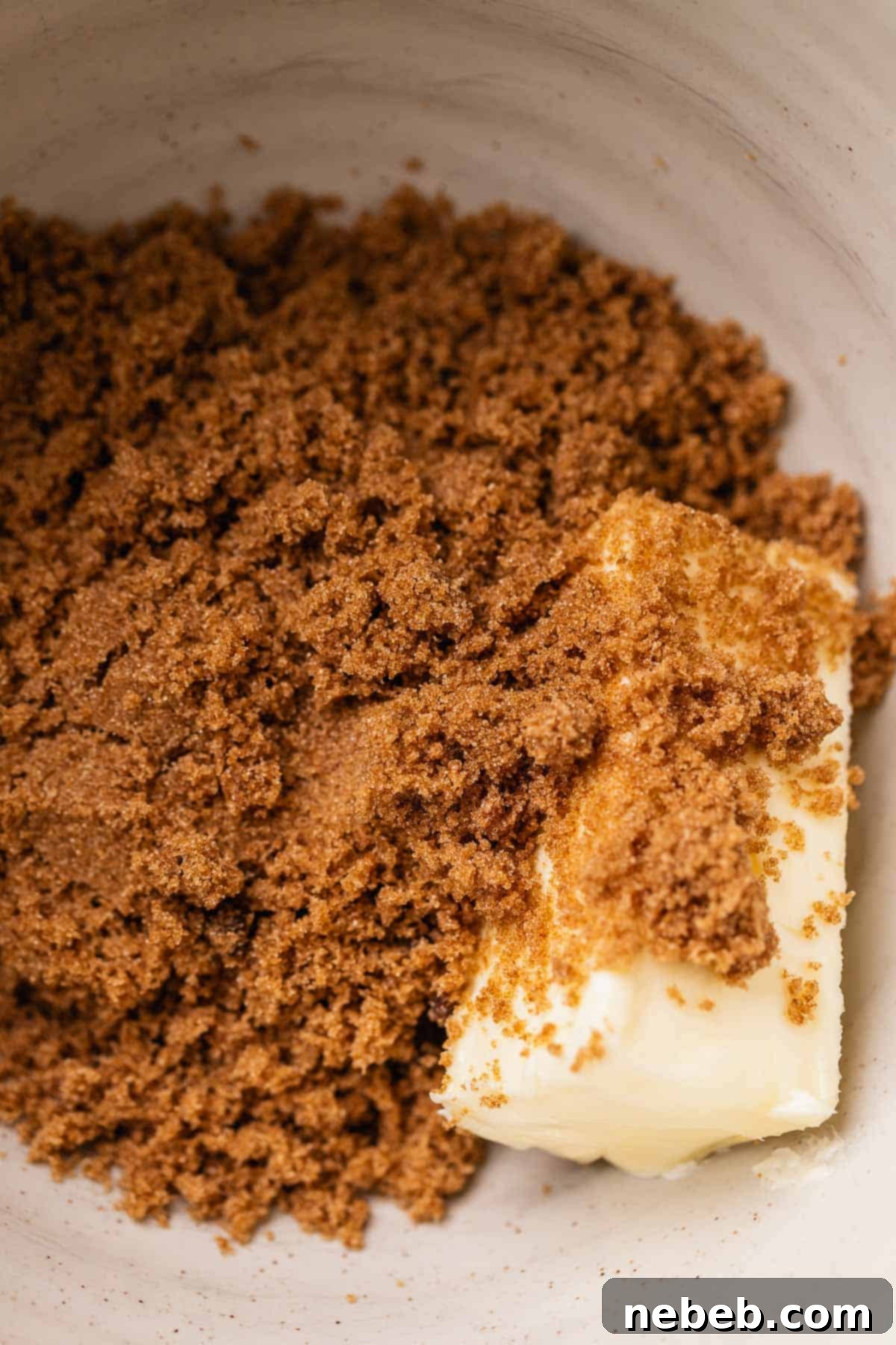 Softened butter and dark brown sugar in a stand mixer bowl, ready for creaming.