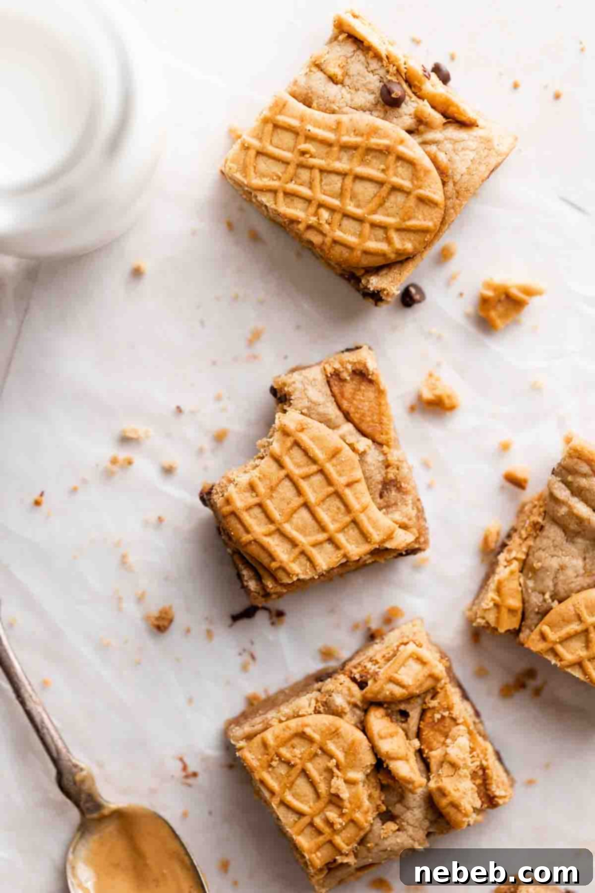 Delicious homemade Nutter Butter bars cooling on parchment paper, showcasing their golden-brown edges and cookie topping.