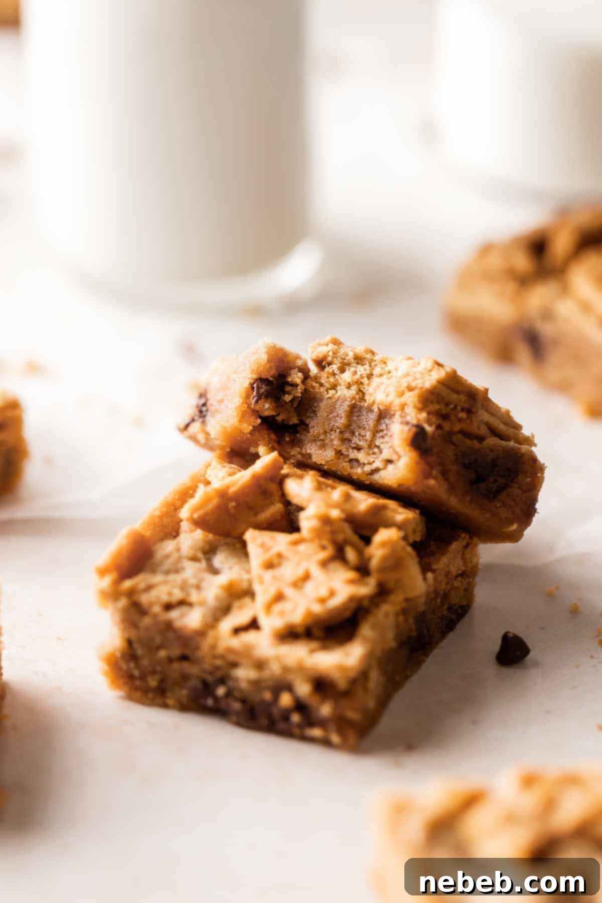 A close-up of a Nutter Butter bar with a bite taken out, showing its chewy interior and chocolate chips.