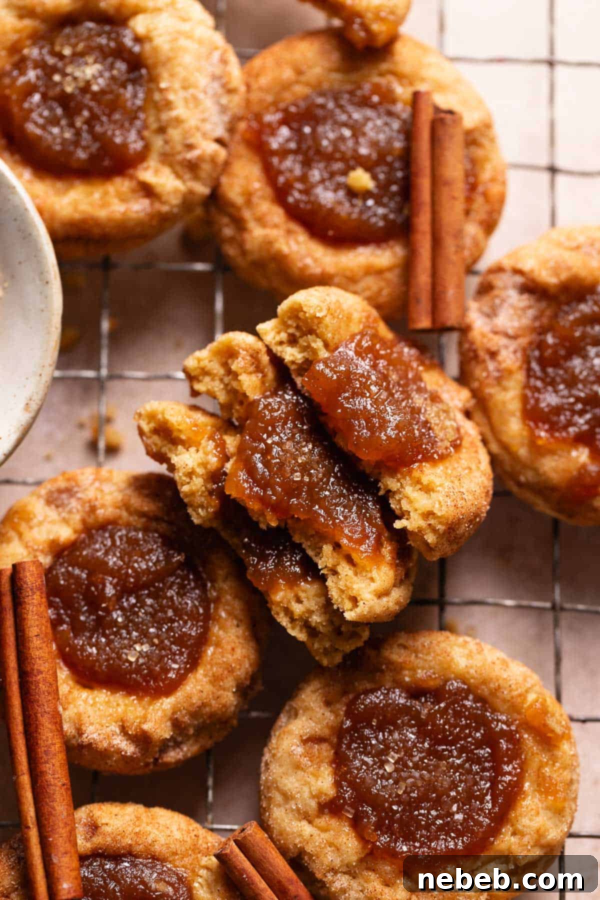 Irresistible Apple Butter Snickerdoodles 2 Apple butter cookies cut in half on a wire cooling rack.