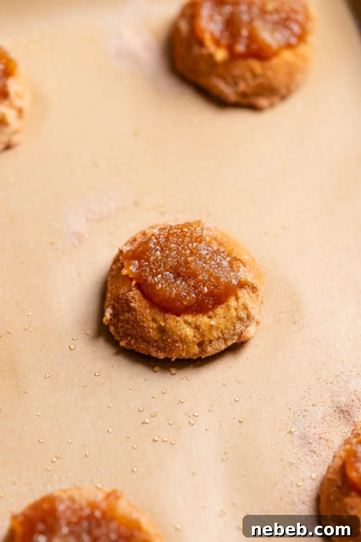 Irresistible Apple Butter Snickerdoodles 7 An apple butter filled snickerdoodle on a baking tray before baking.