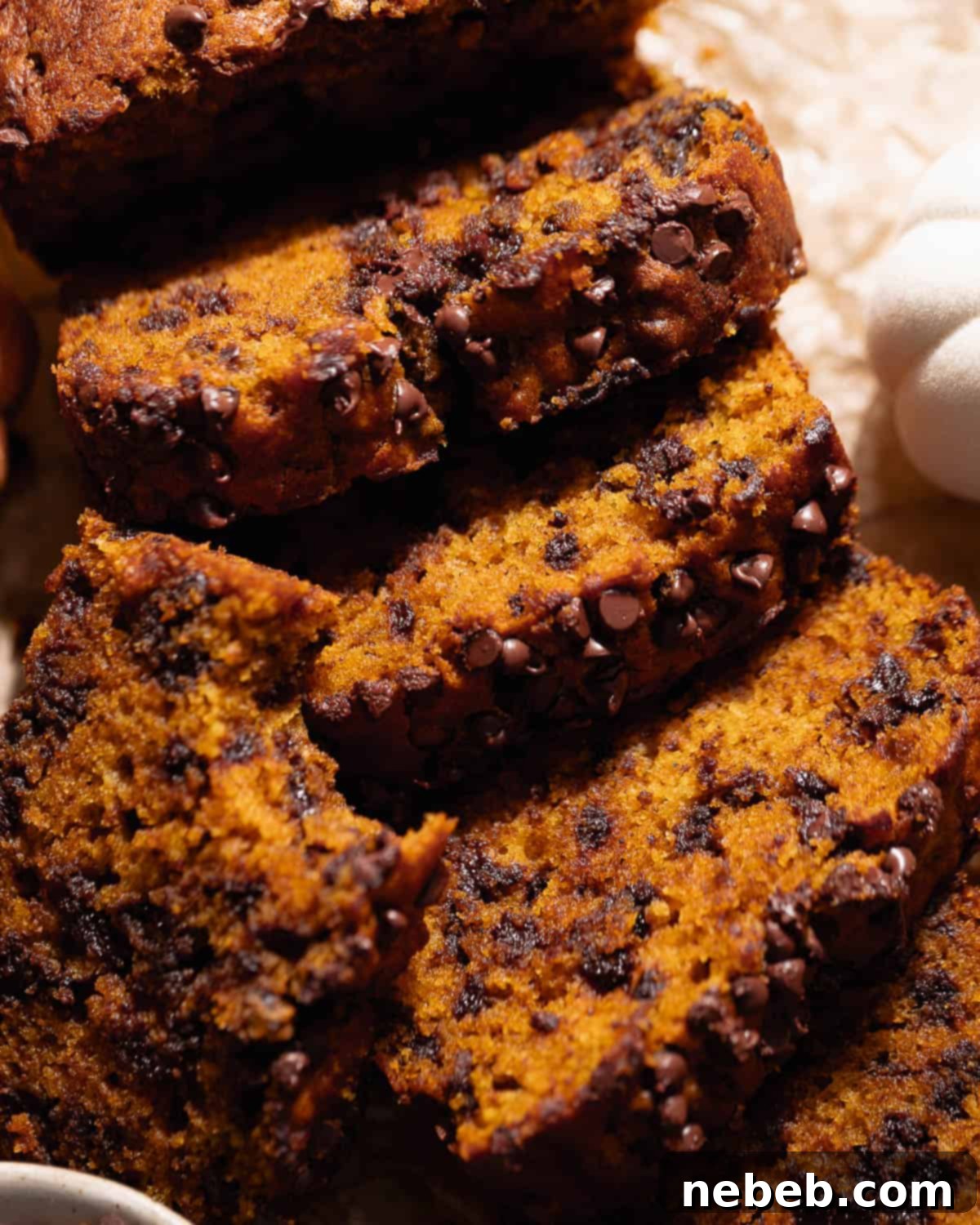 Slices of perfectly baked chocolate chip pumpkin bread, showing the rich color and moist texture.