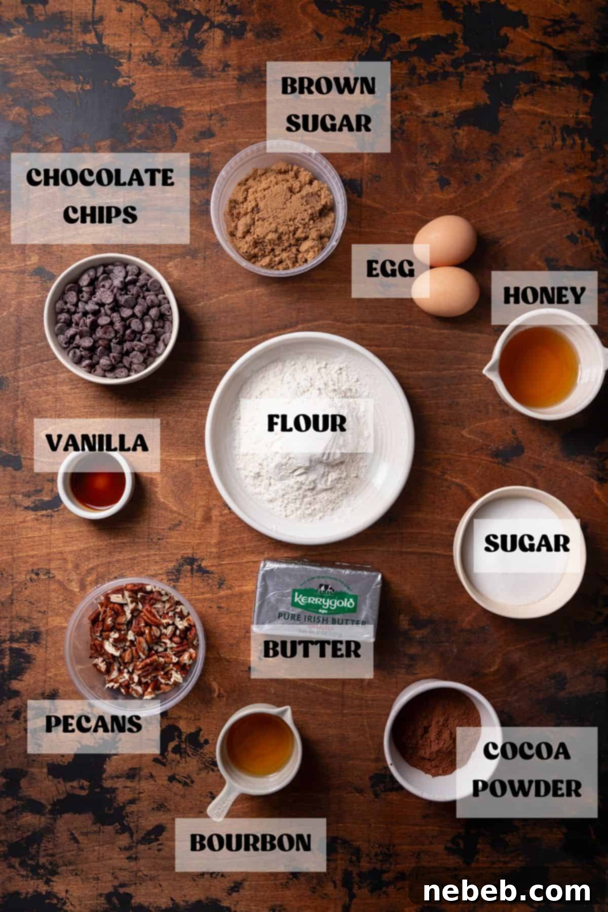 Ingredients needed to make brownies with pecan pie topping, including sugars, eggs, butter, bourbon, flour, cocoa, pecans, and honey.