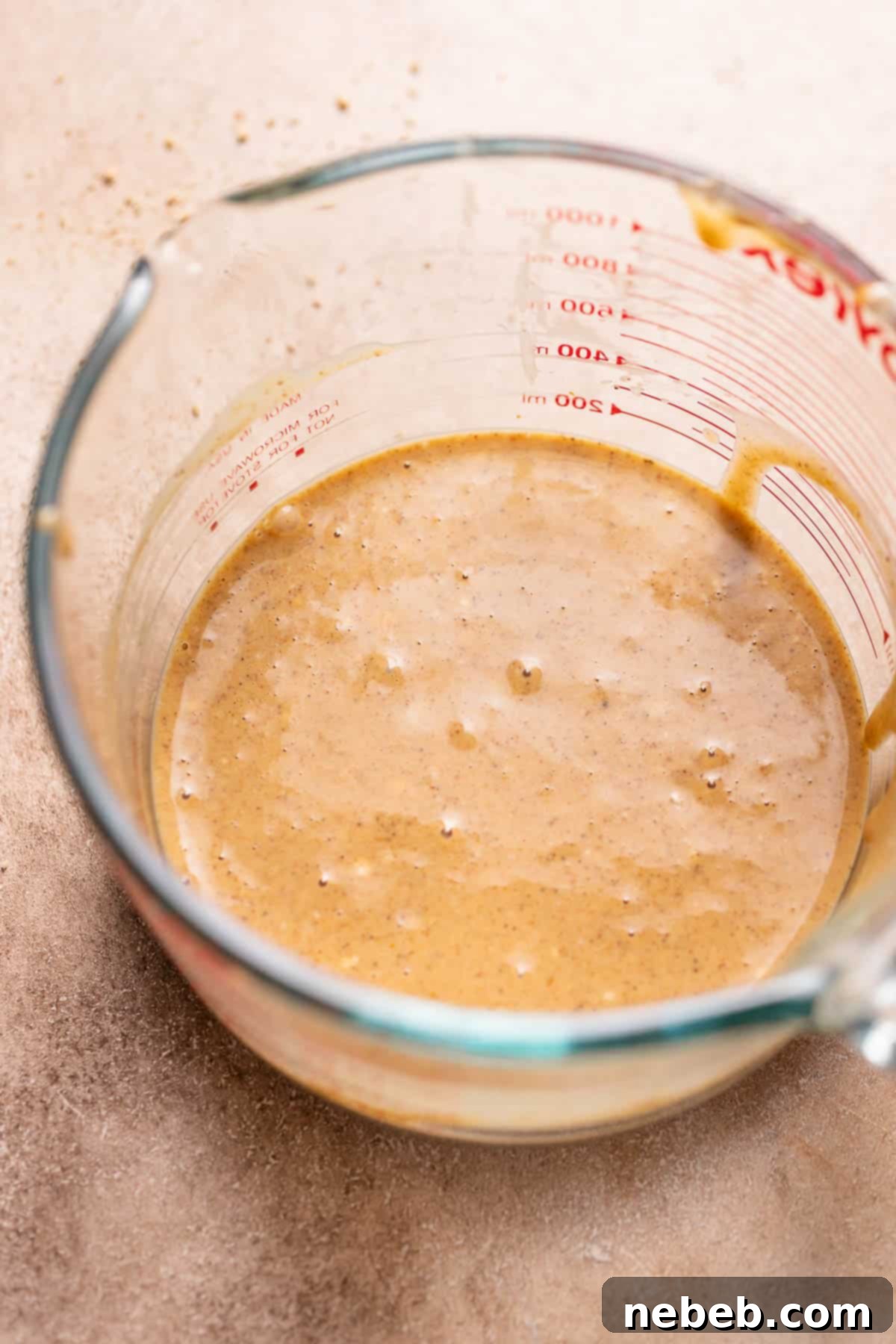 A bowl of creamy, spiced pumpkin cheesecake filling.