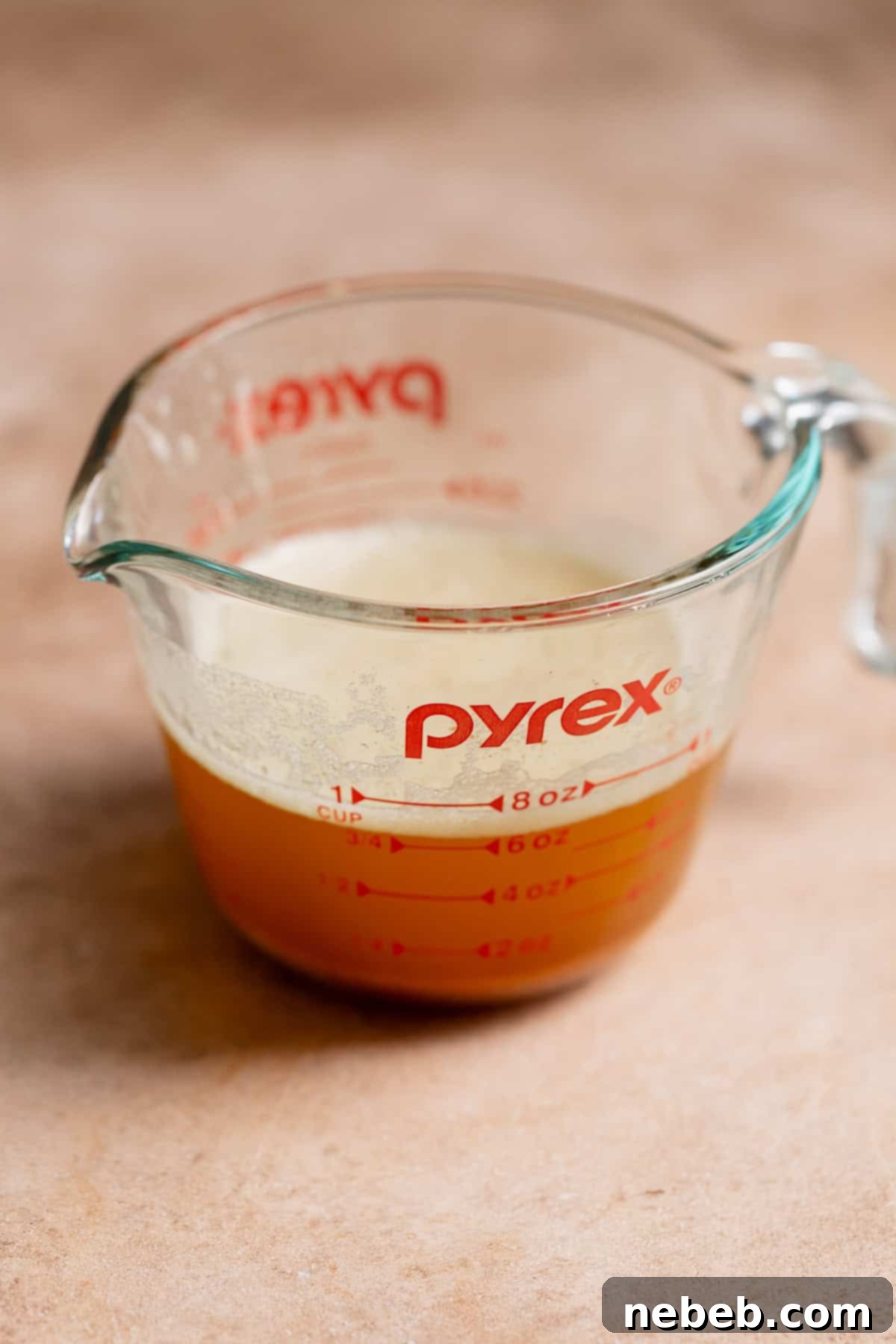 Decadent Brown Butter Toffee Chocolate Chip Cookies 5 A glass measuring cup with browned butter.
