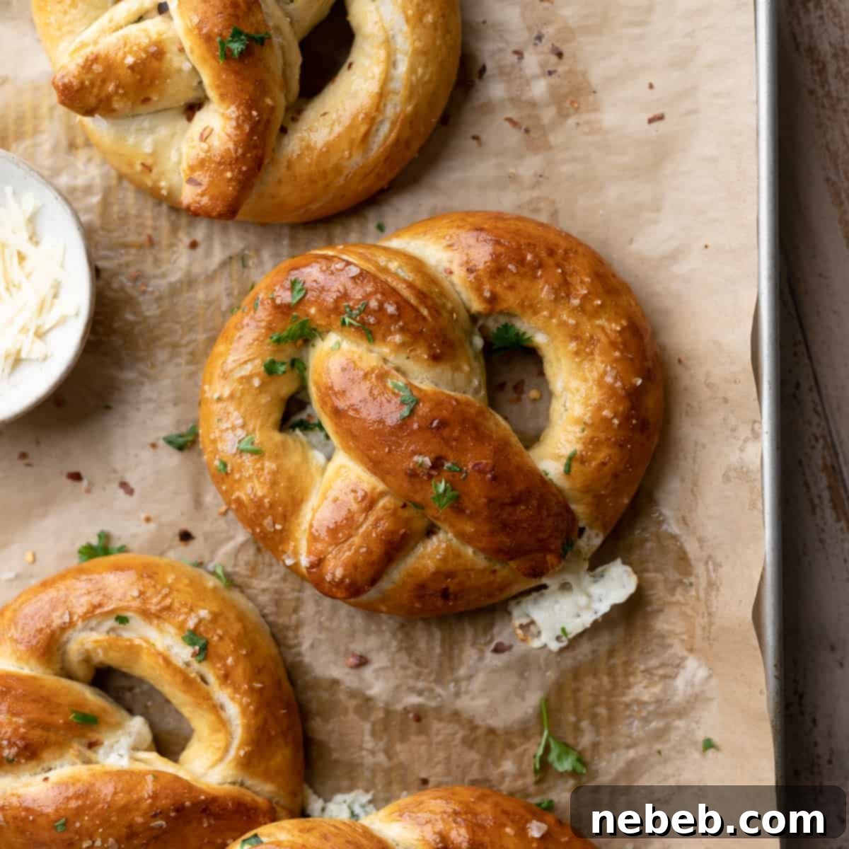 Creamy Spinach Artichoke Stuffed Pretzels 10 stuffed pretzels brushed with butter on a baking tray.