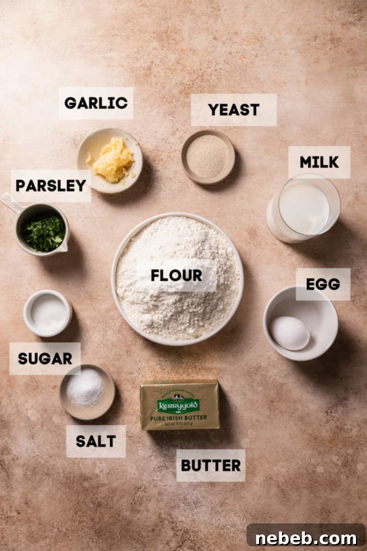 Ingredients needed to make garlic bread rolls in bowls with labels.
