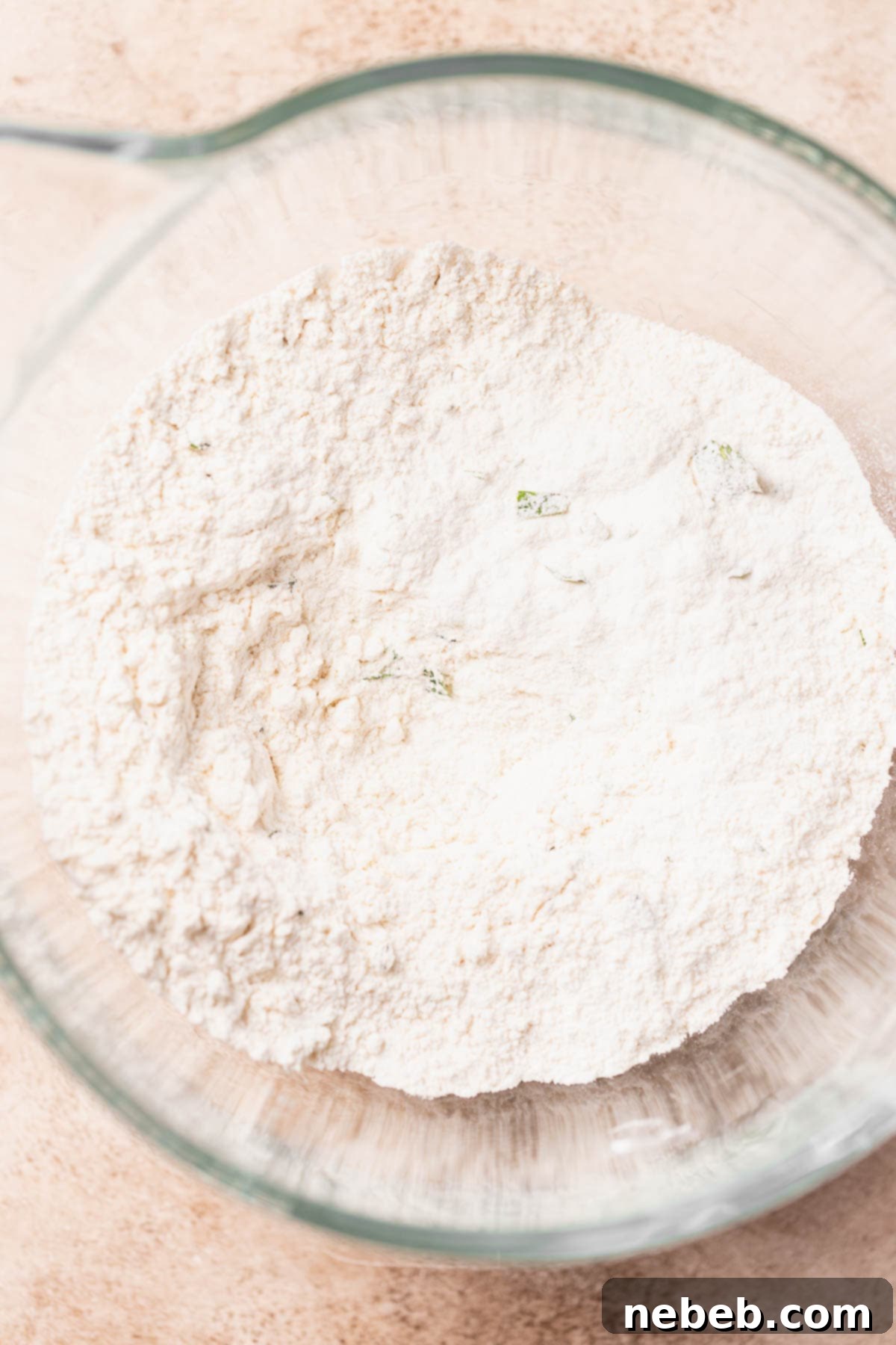 A glass mixing bowl with the whisked dry ingredients.