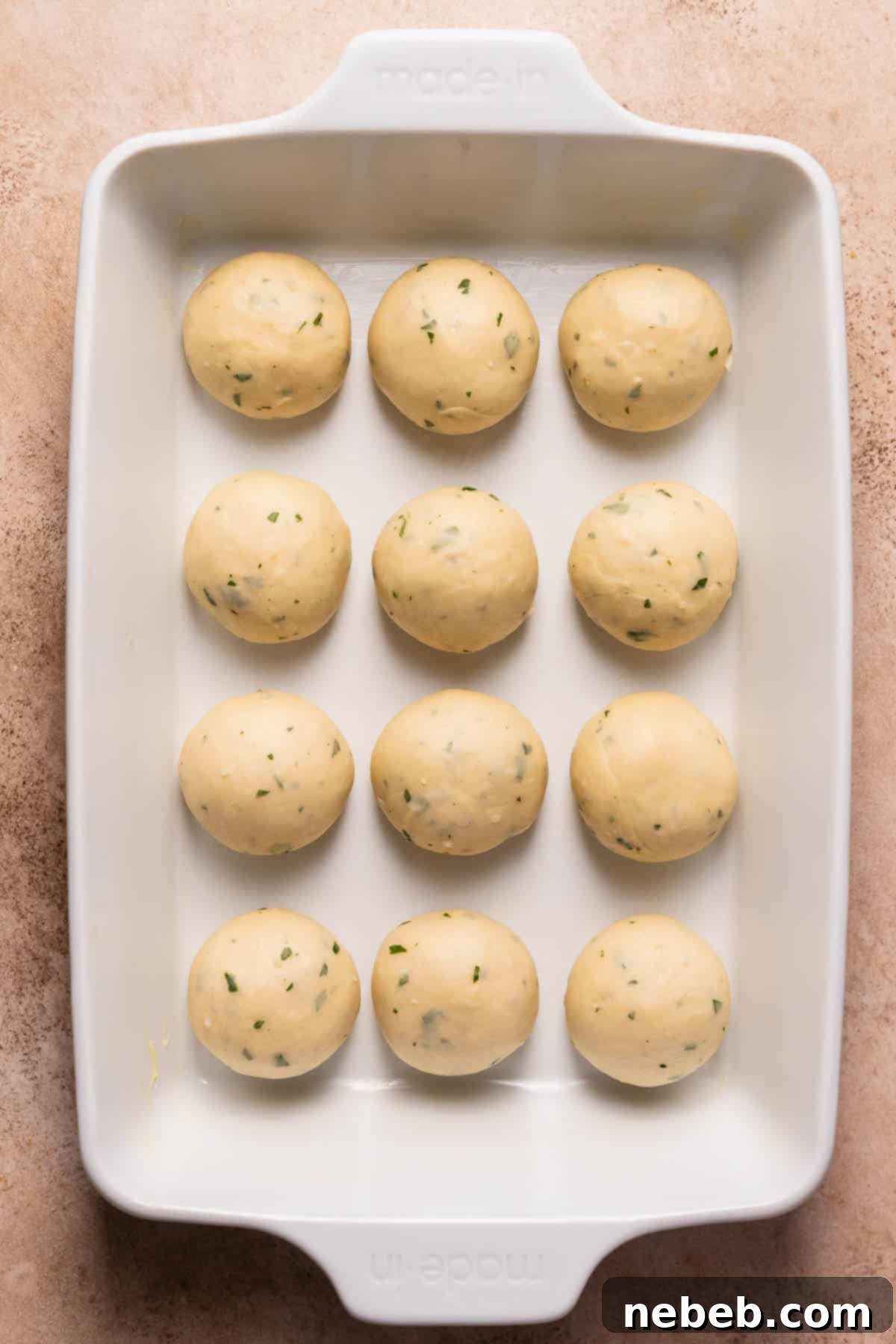 A baking pan with the garlic bread rolls before they've risen.