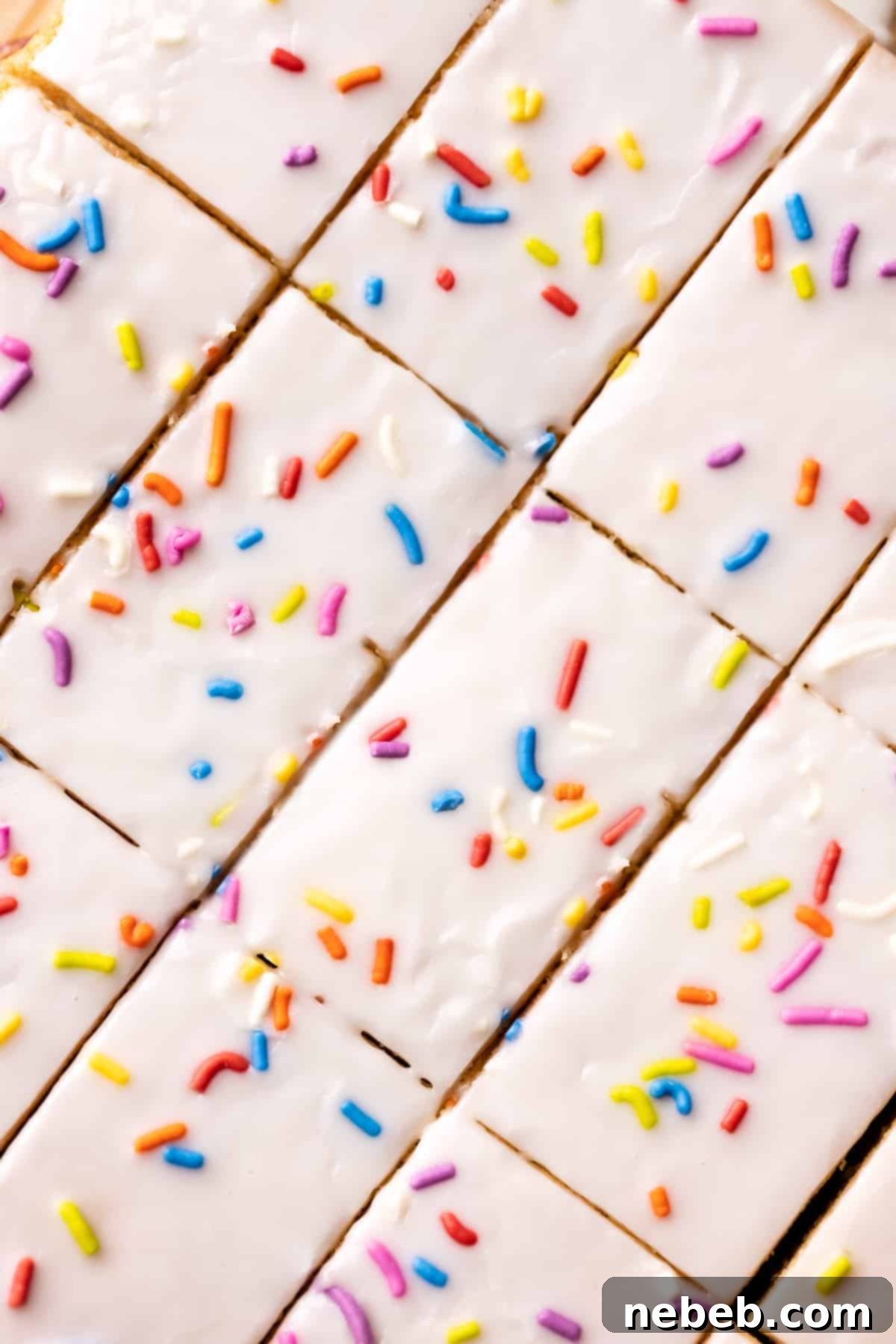 Pop-Tart Magic Cookie Bars 6 Freshly baked Pop-Tart cookie bars, perfectly cut into uniform rectangles and arranged, highlighting the golden-brown cookie layers and the delicious strawberry filling.