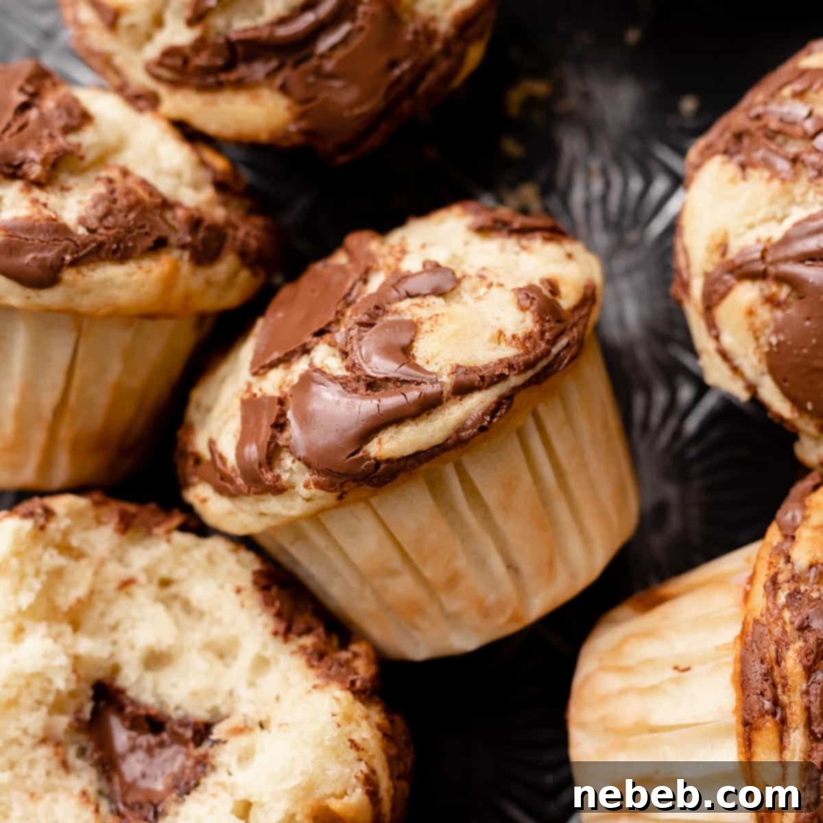 Nutella Swirl Banana Muffins 11 banana nutella muffin with nutella swirled into the top.