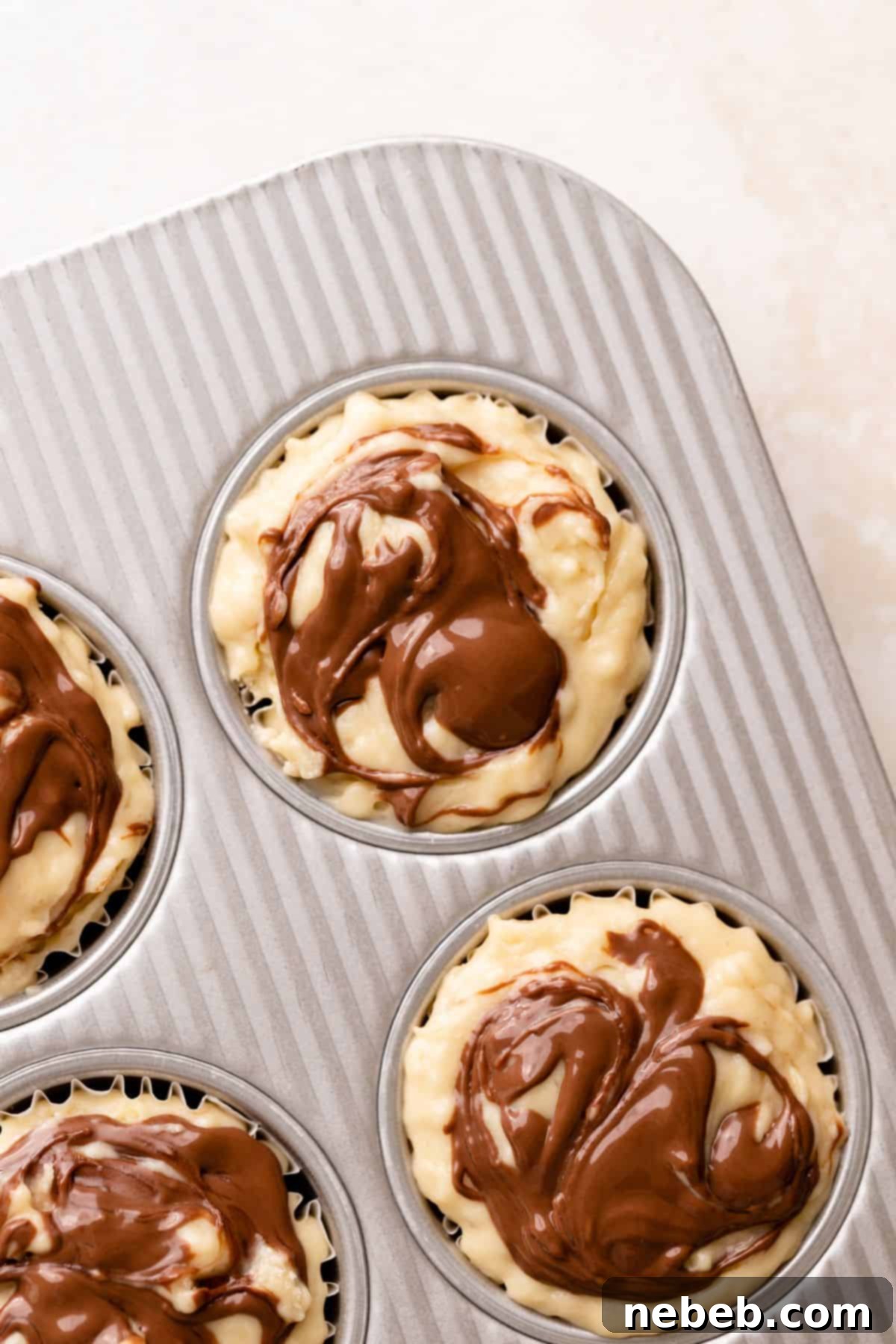 Nutella Swirl Banana Muffins 9 Nutella swirled on the tops of the muffin batter.