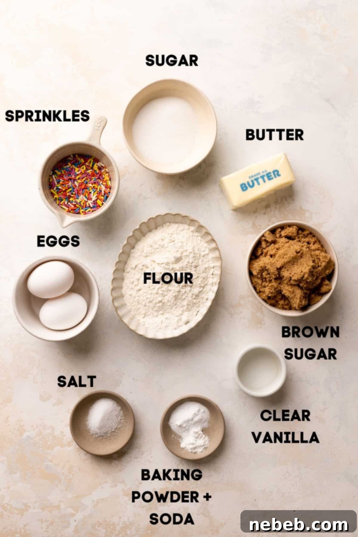 ingredients needed to make sugar cookies in bowls with labels.