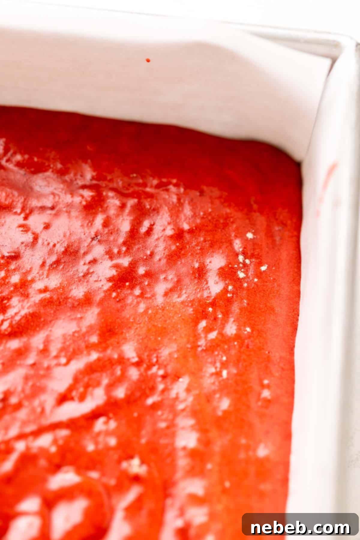 A baking pan with the red velvet brownie batter before baking.