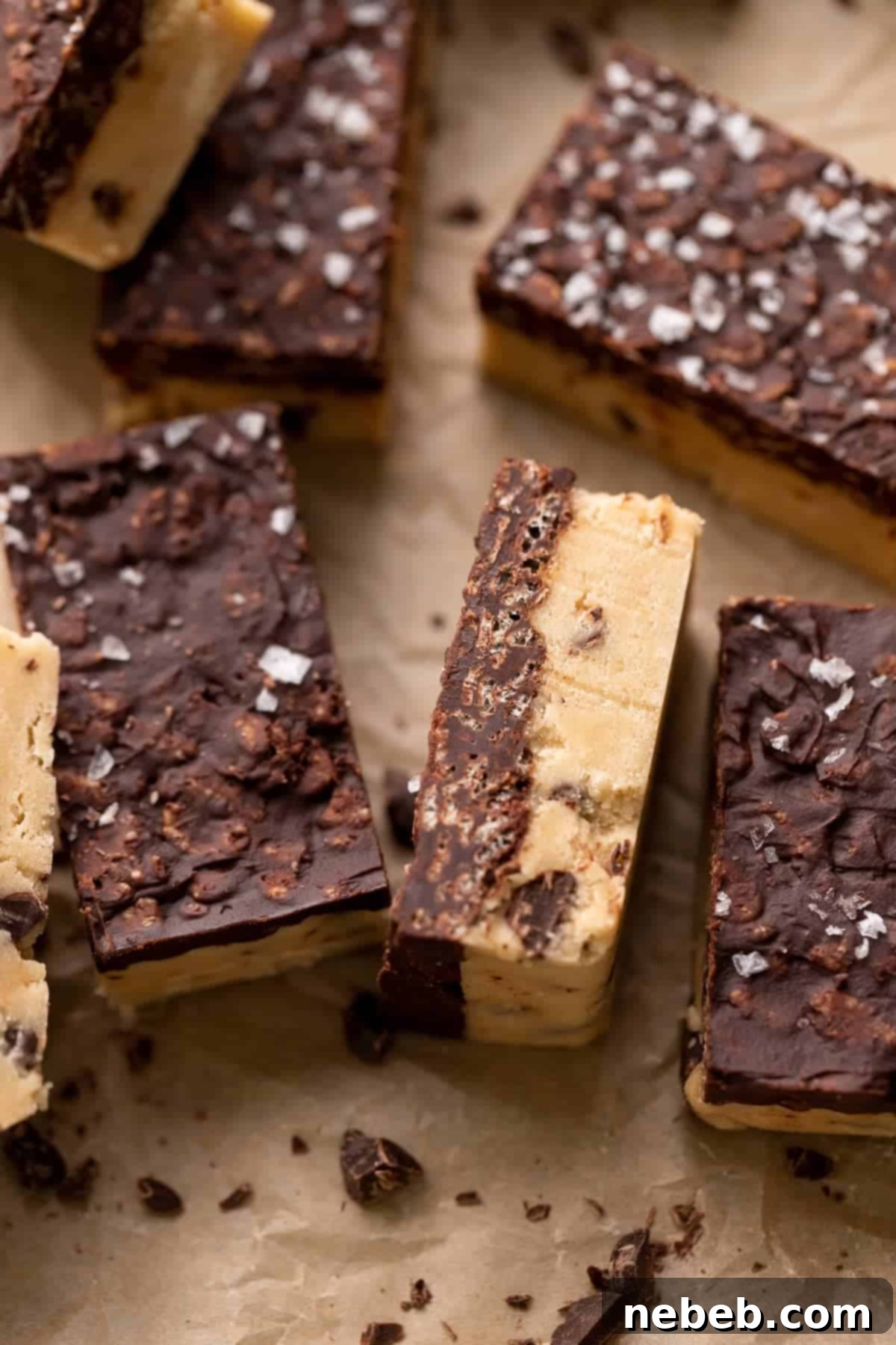 Golden Crunch Cookie Dough Bars 6 chocolate chip cookie dough bars on parchment paper, ready to be cut.