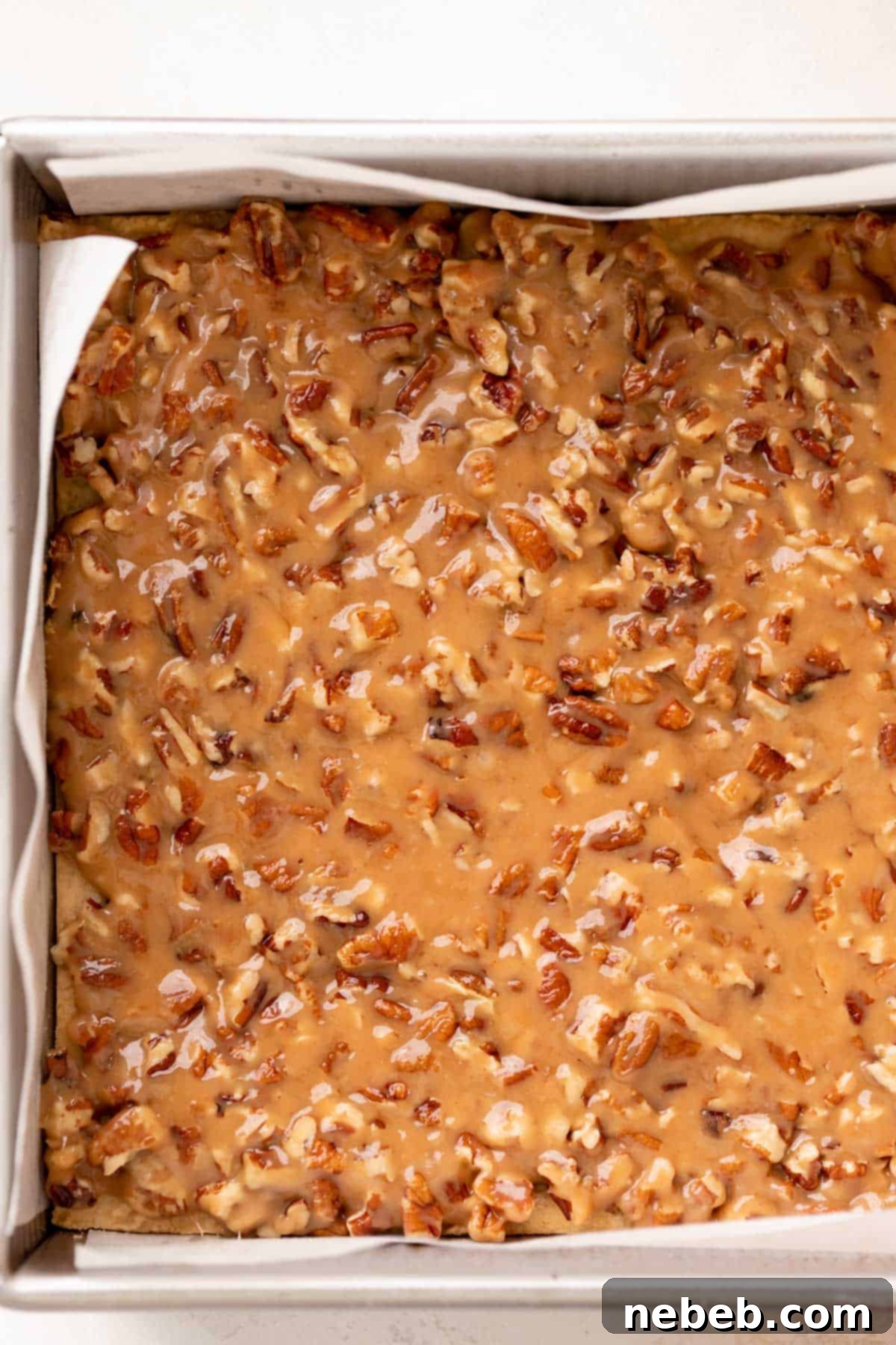 the caramel pecan bars in a baking pan before baking.