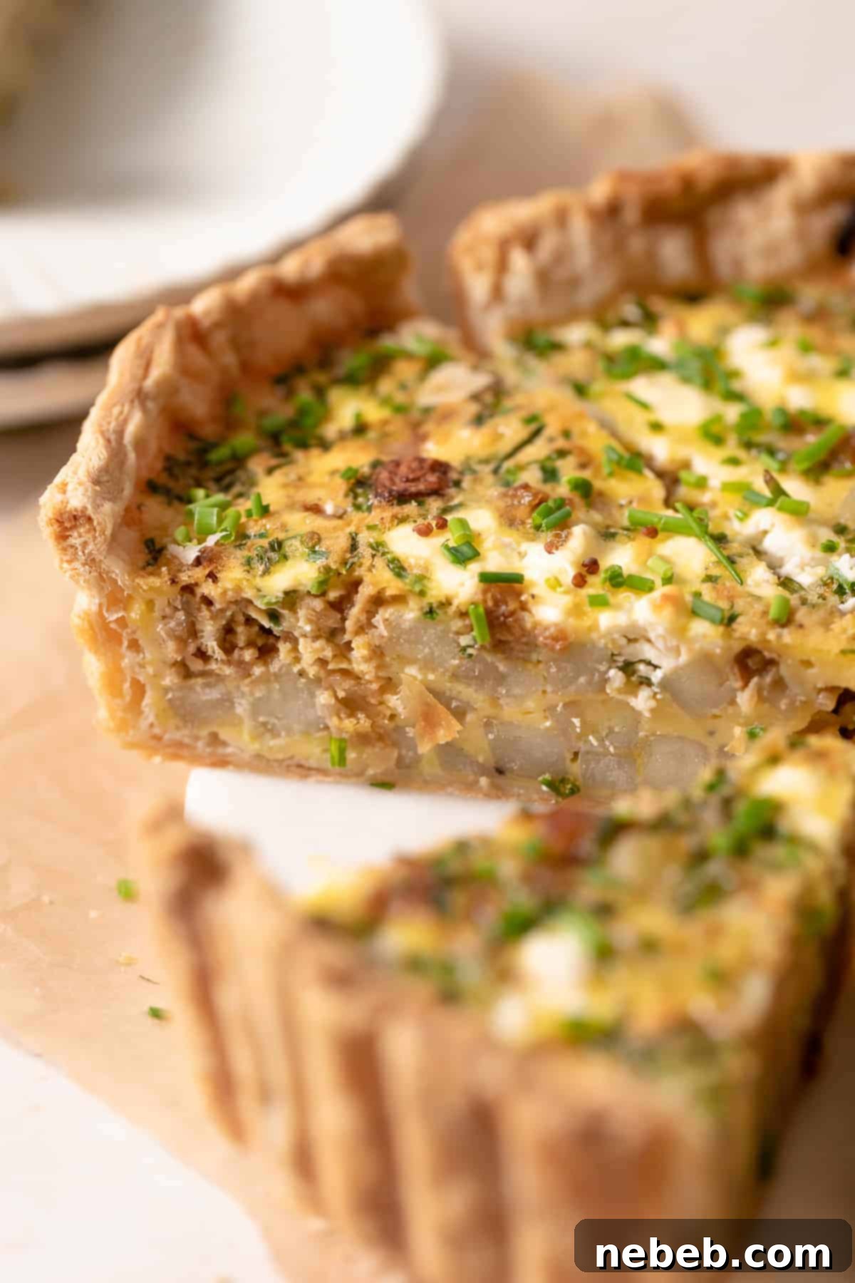 Flaky Deep Dish Quiche 2 Puff pastry quiche cut into slices, showcasing its flaky crust and rich filling.