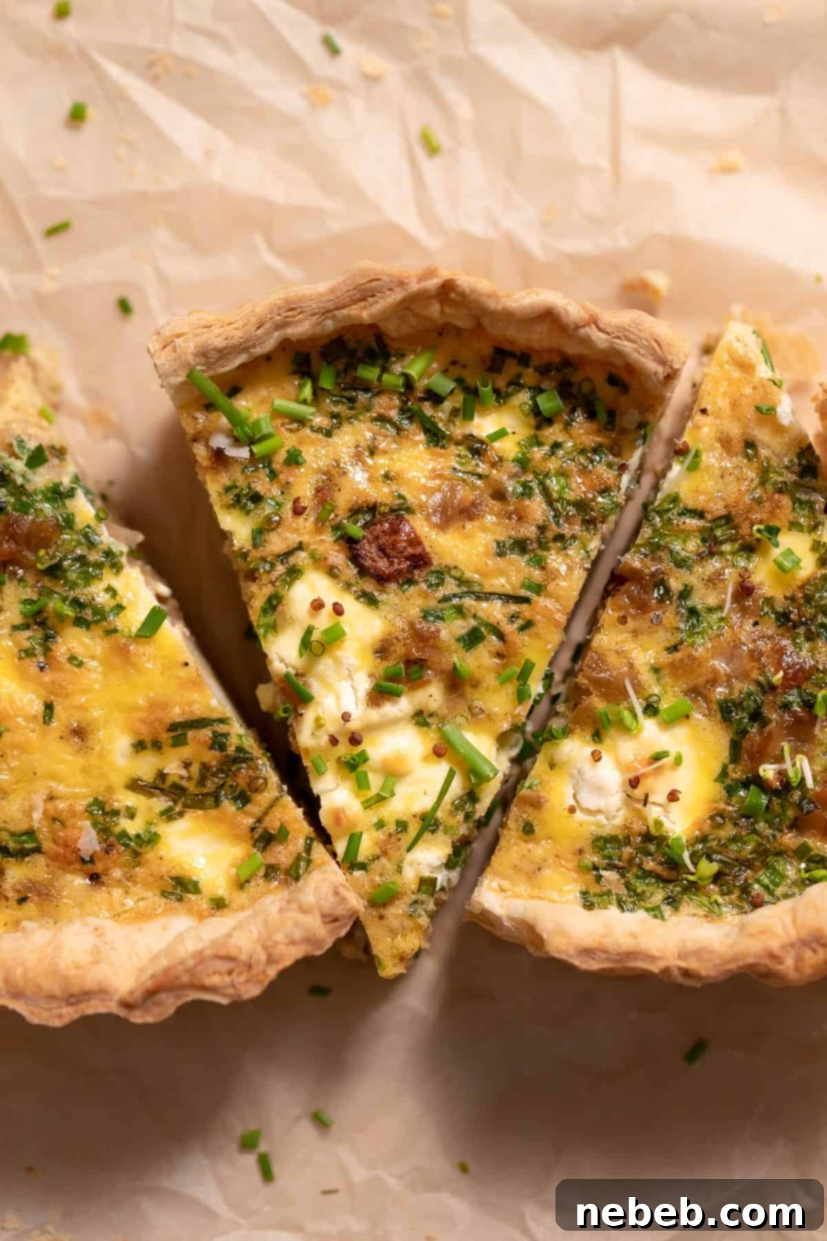 Flaky Deep Dish Quiche 3 Three slices of puff pastry quiche on parchment paper, ready to be served.