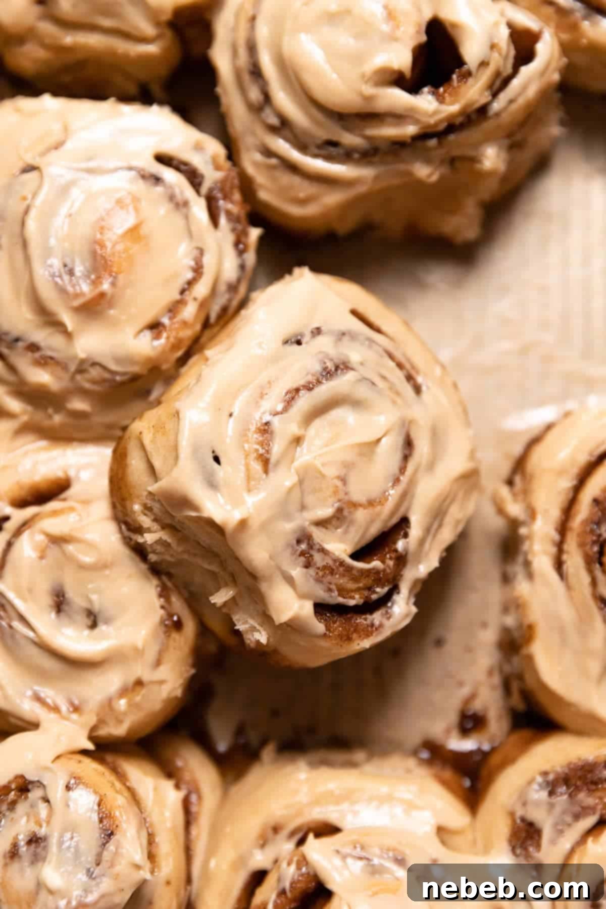coffee cinnamon rolls with coffee frosting in a baking pan.