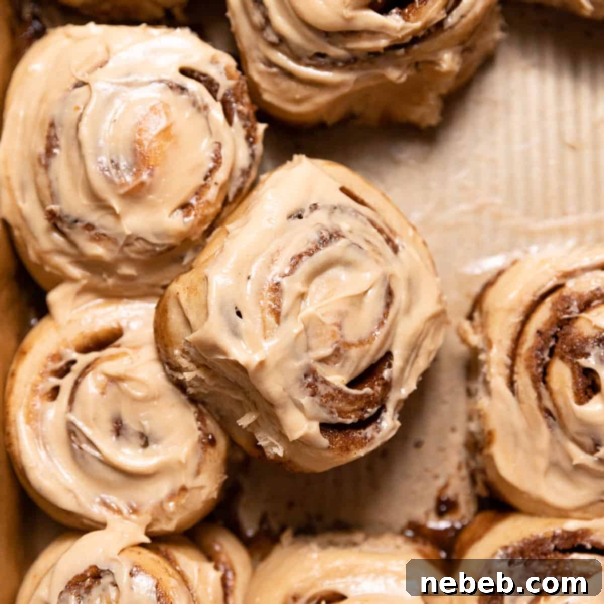 coffee cinnamon rolls with coffee frosting in a baking pan.