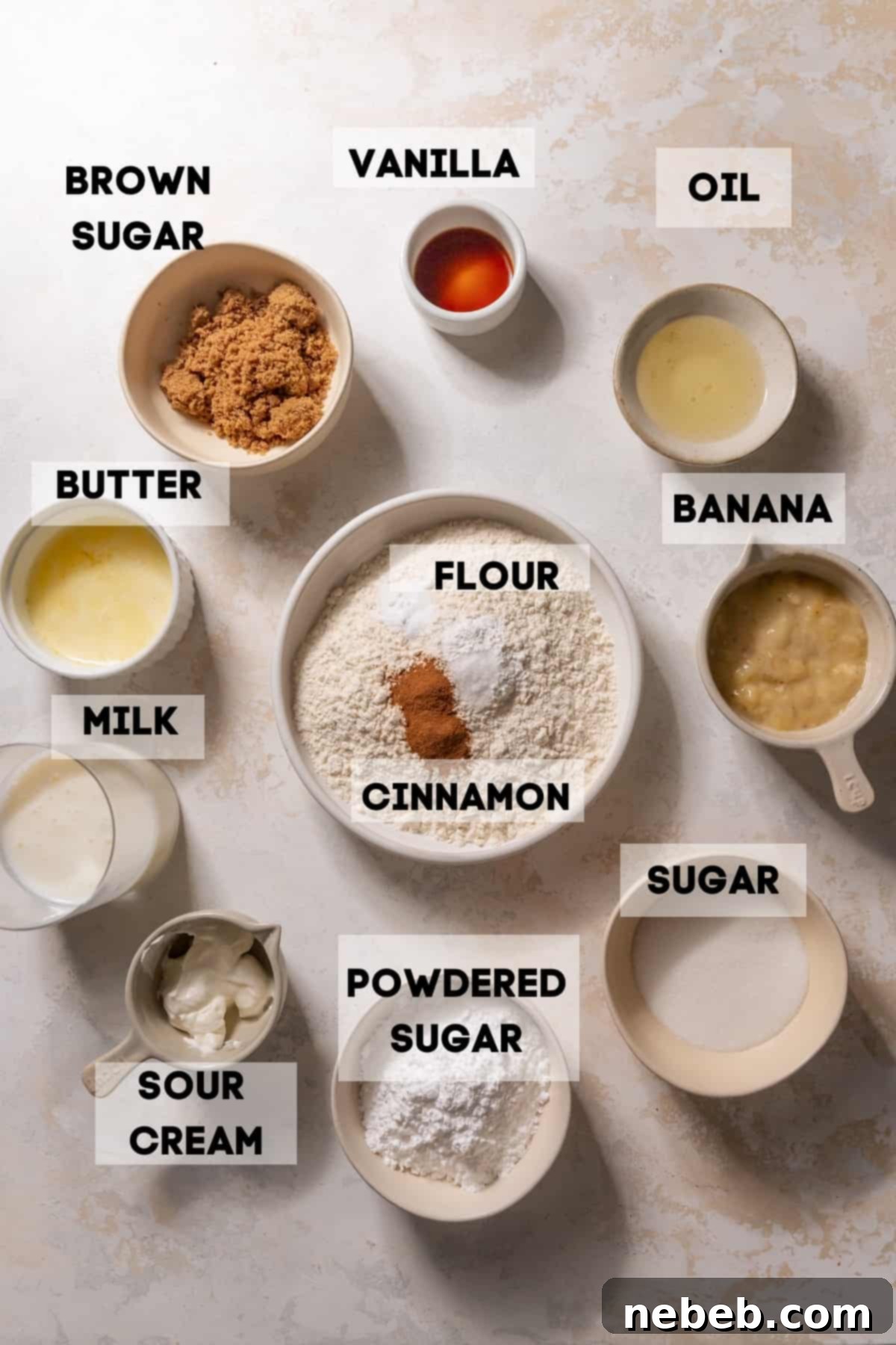 Ingredients for banana donuts laid out in bowls with labels, ready for baking.