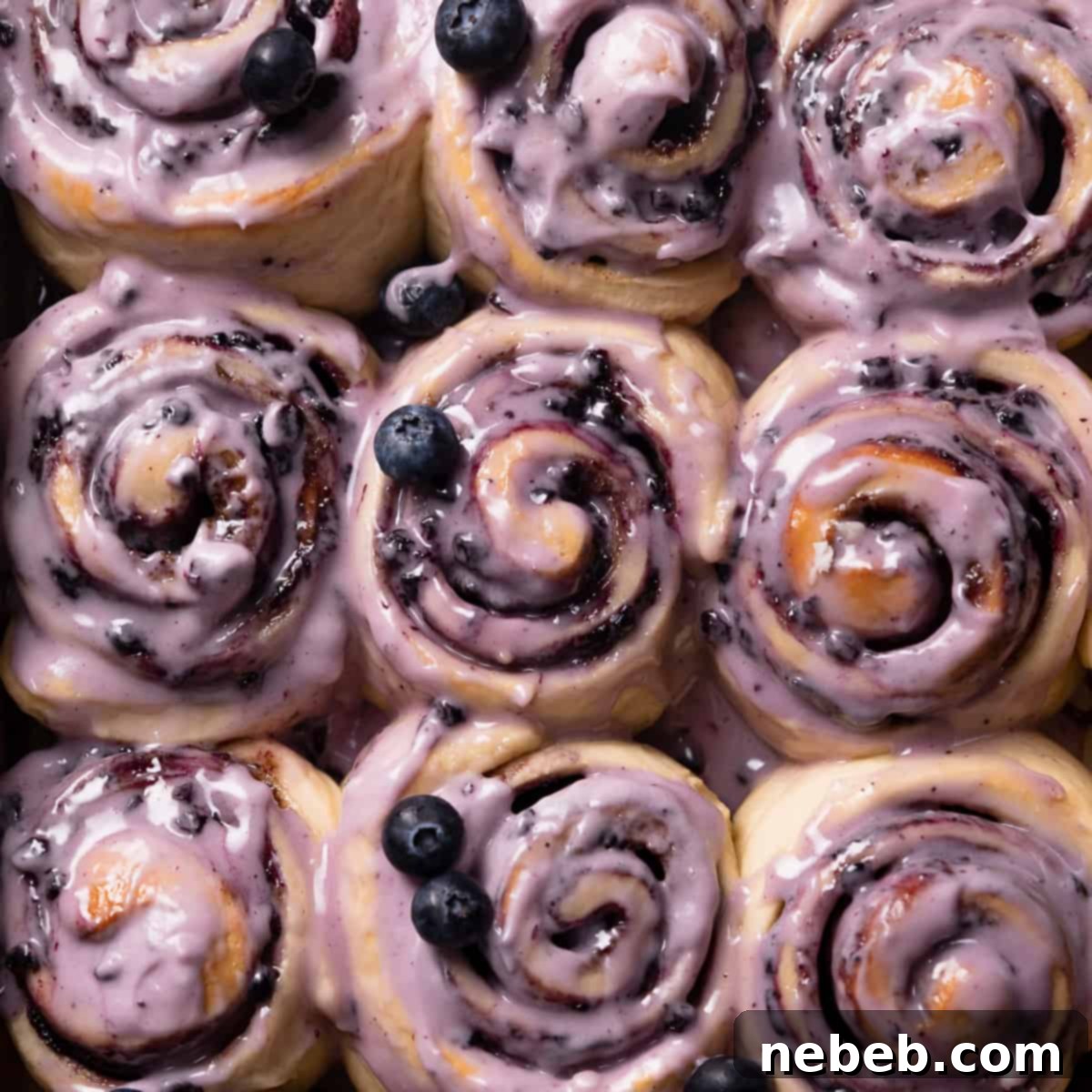 blueberry cinnamon rolls with blueberry glaze on top.