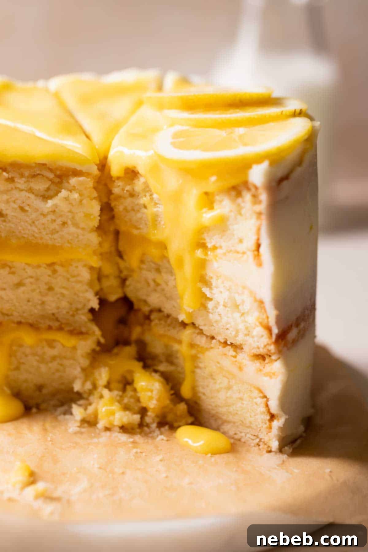 A beautifully decorated lemon bar cake, topped with vibrant lemon curd and fresh lemon slices, ready to be served.
