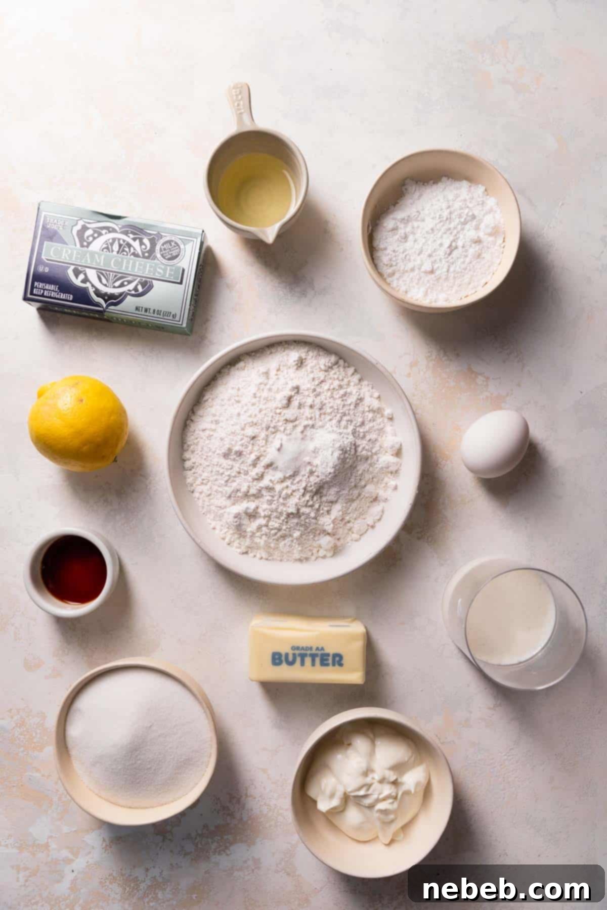 A collection of fresh ingredients laid out on a surface, including lemons, eggs, butter, and flour, essential for making the lemon bar cake.