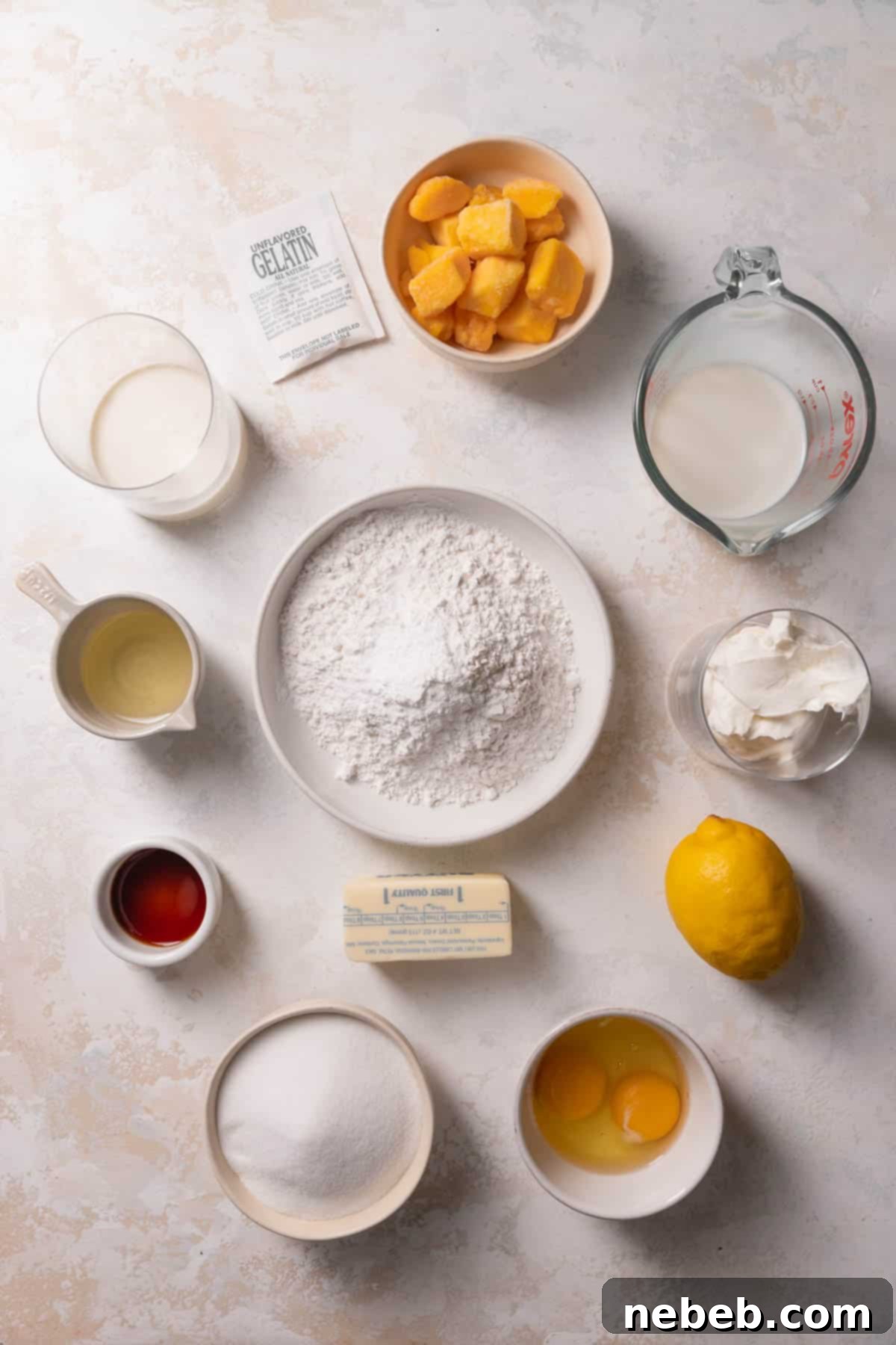 Assorted ingredients laid out for making a mango mousse cake.