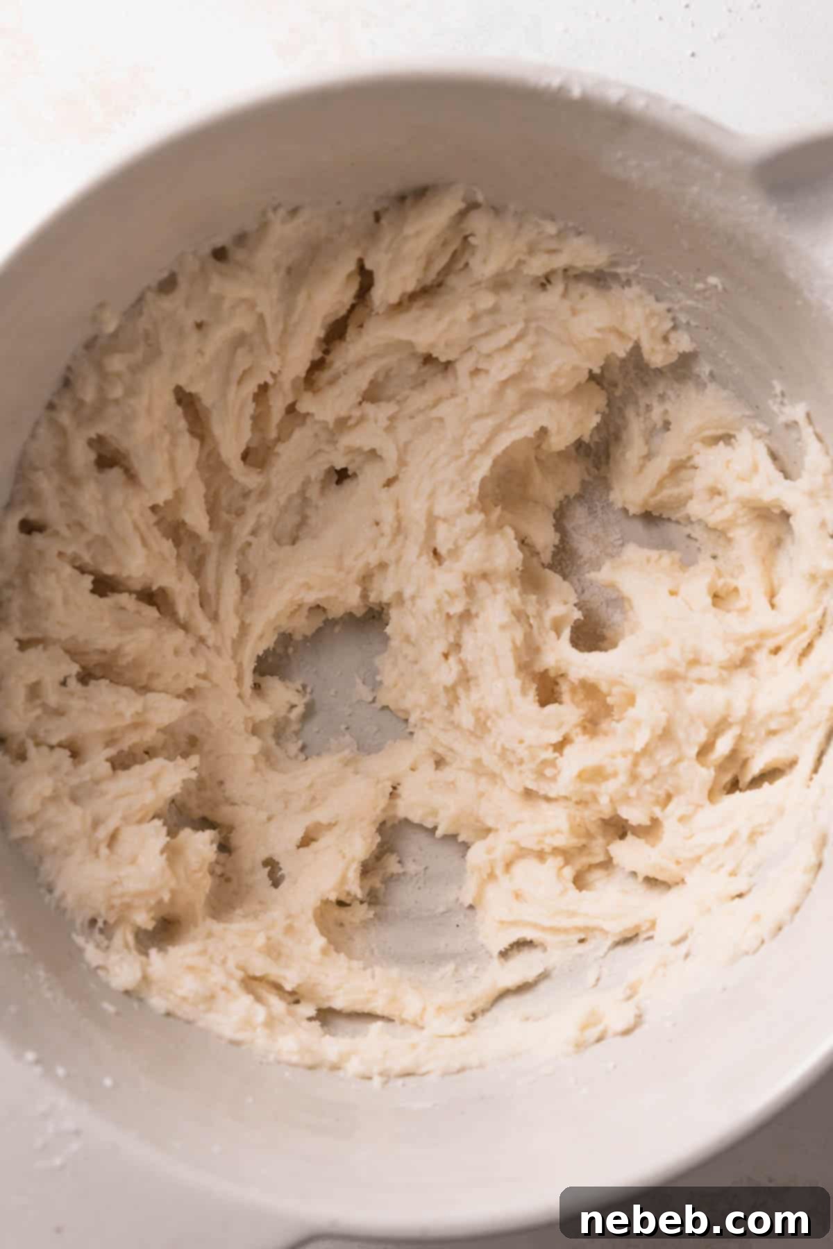 Vanilla cake batter in a mixing bowl, ready for baking.