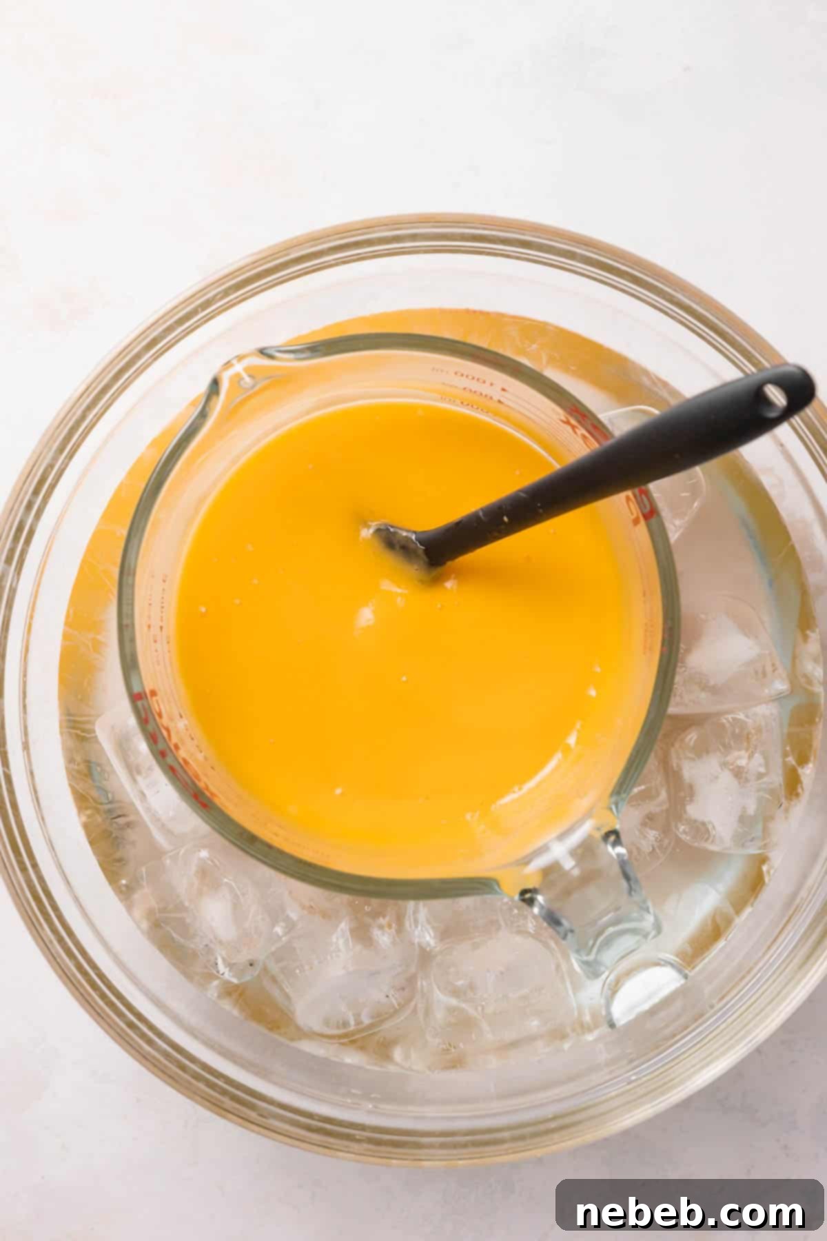 Mango puree cooling in an ice bath to reach room temperature.