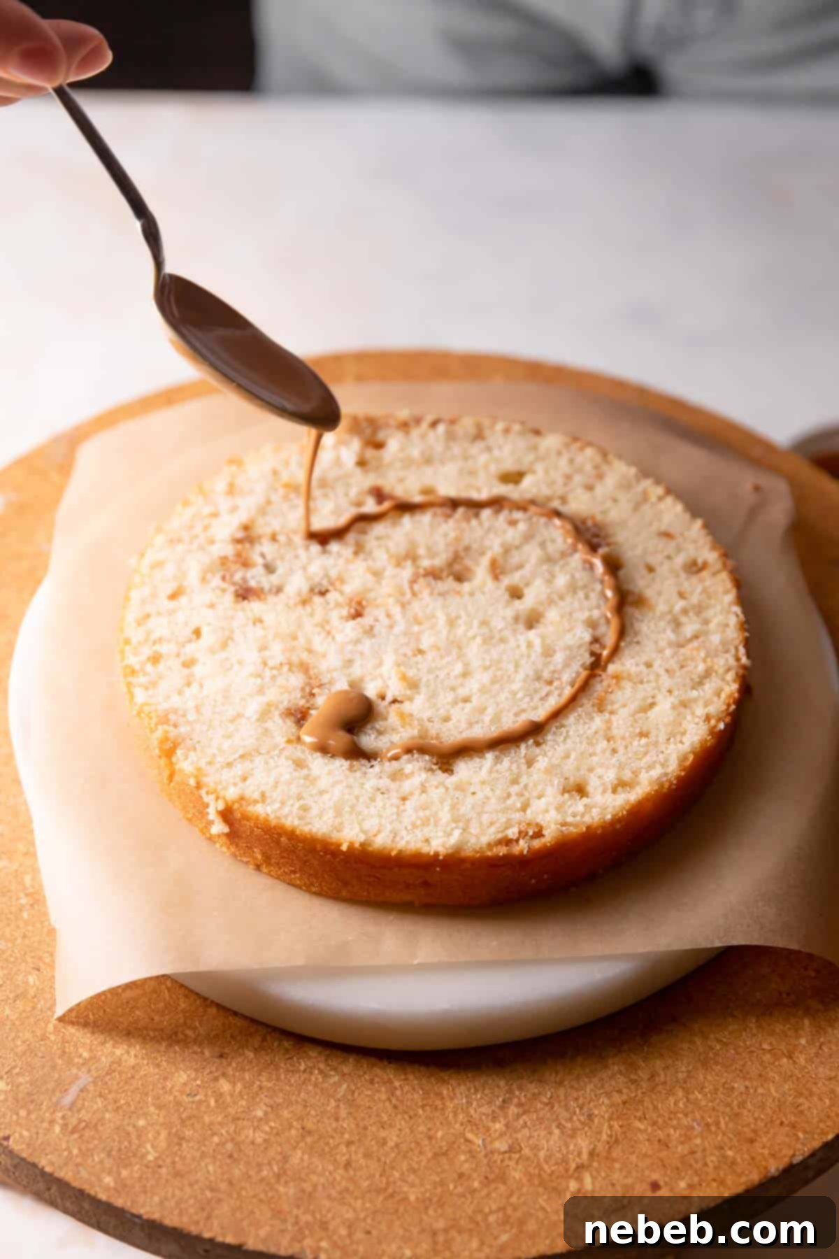 drizzling cookie butter on top of the cake layer.