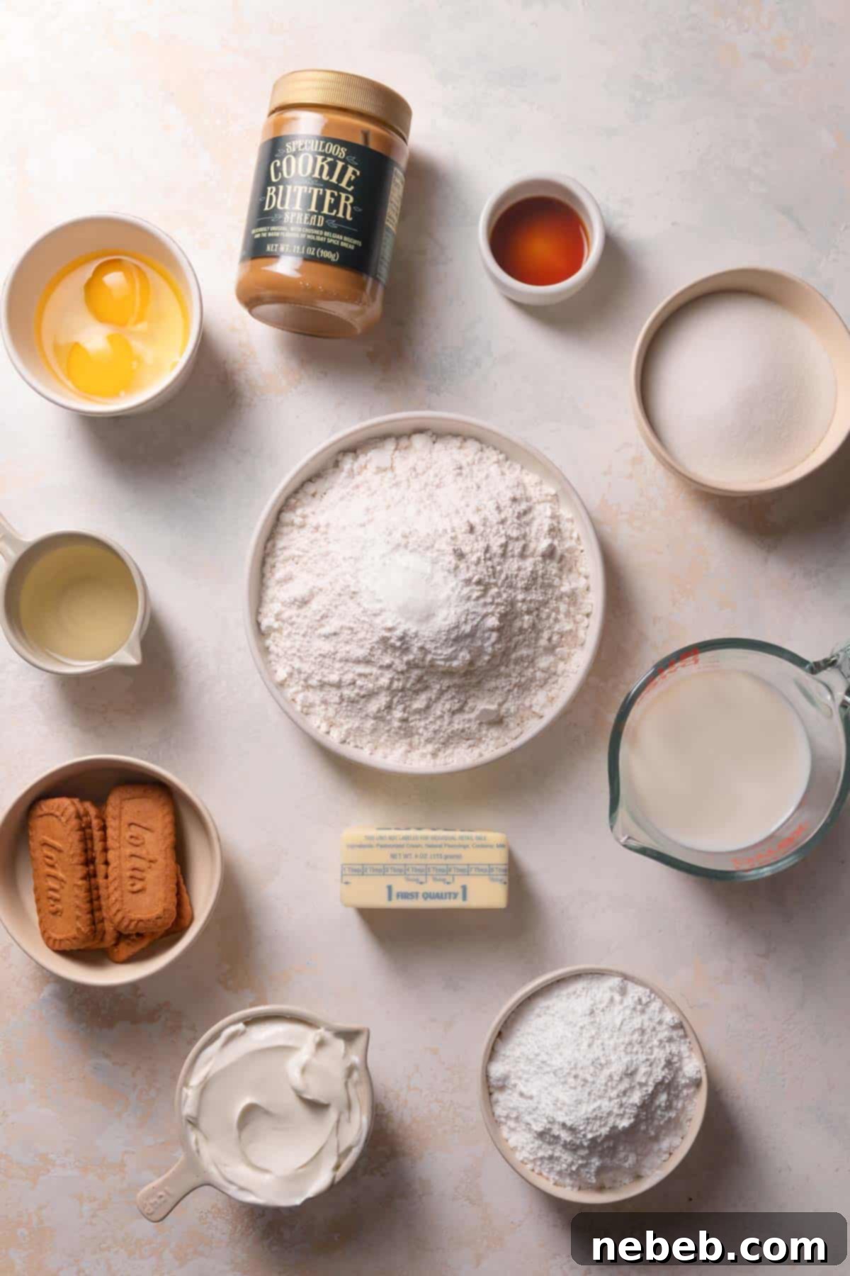 ingredients needed to make cookie butter cake in a bowl with labels.