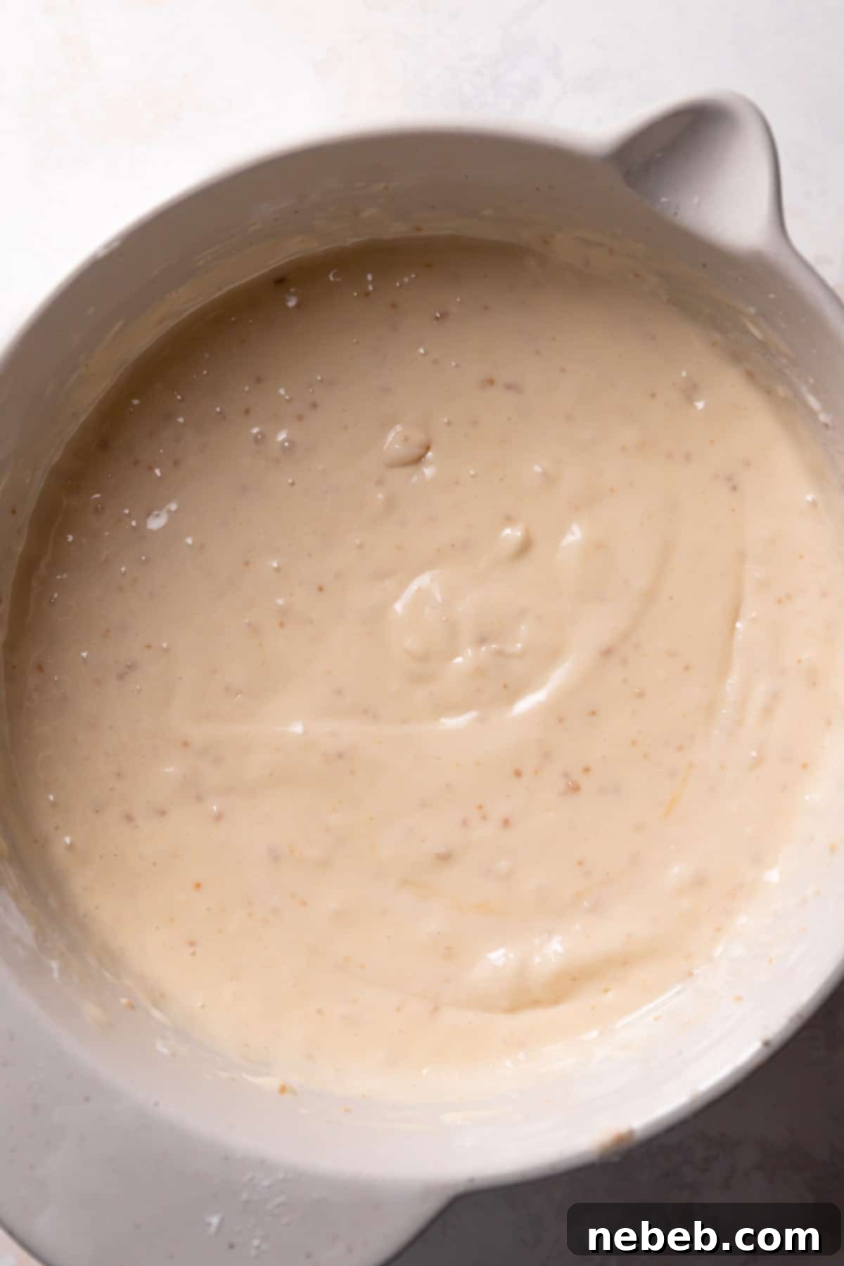 cookie butter cake batter in a mixing bowl.