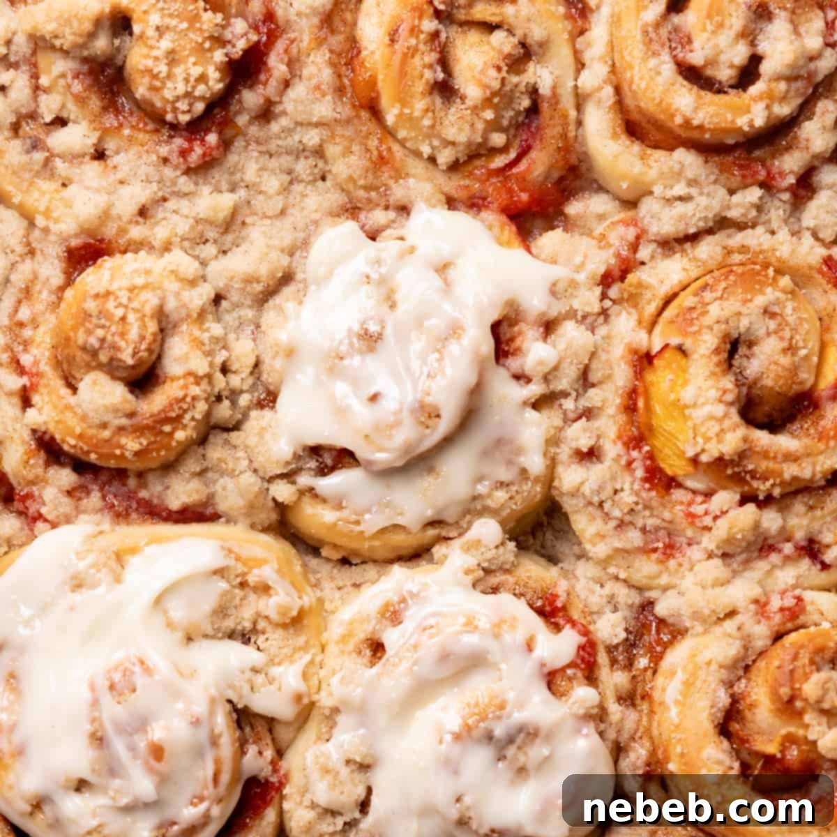 peach cobbler cinnamon rolls with cream cheese icing.
