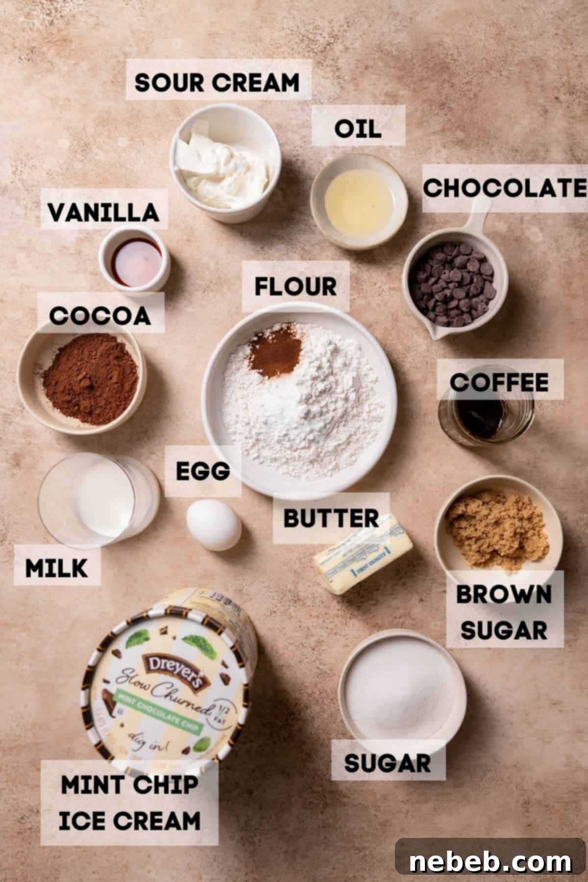 Individual bowls containing all the measured ingredients for the mint chocolate chip ice cream cake, neatly labeled.