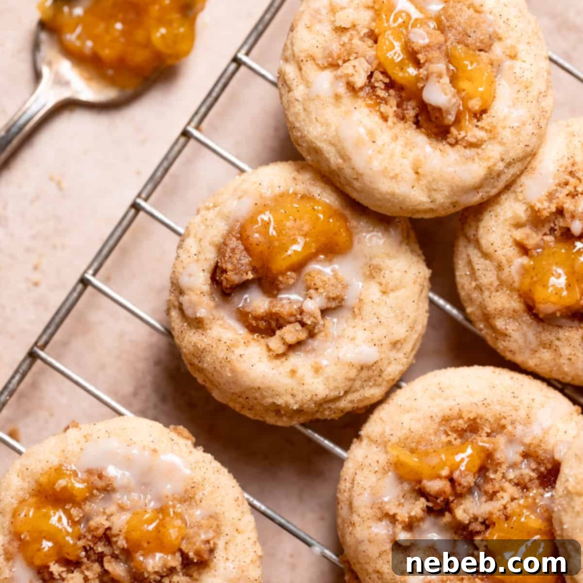 peach cobbler cookies with peach jam and glaze on top.