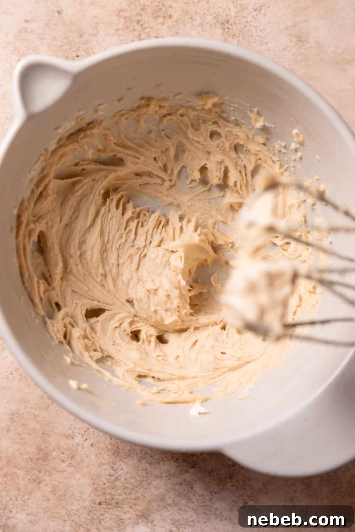 Creamed butter, granulated sugar, and brown sugar in a stand mixer bowl, showing a light and fluffy texture.