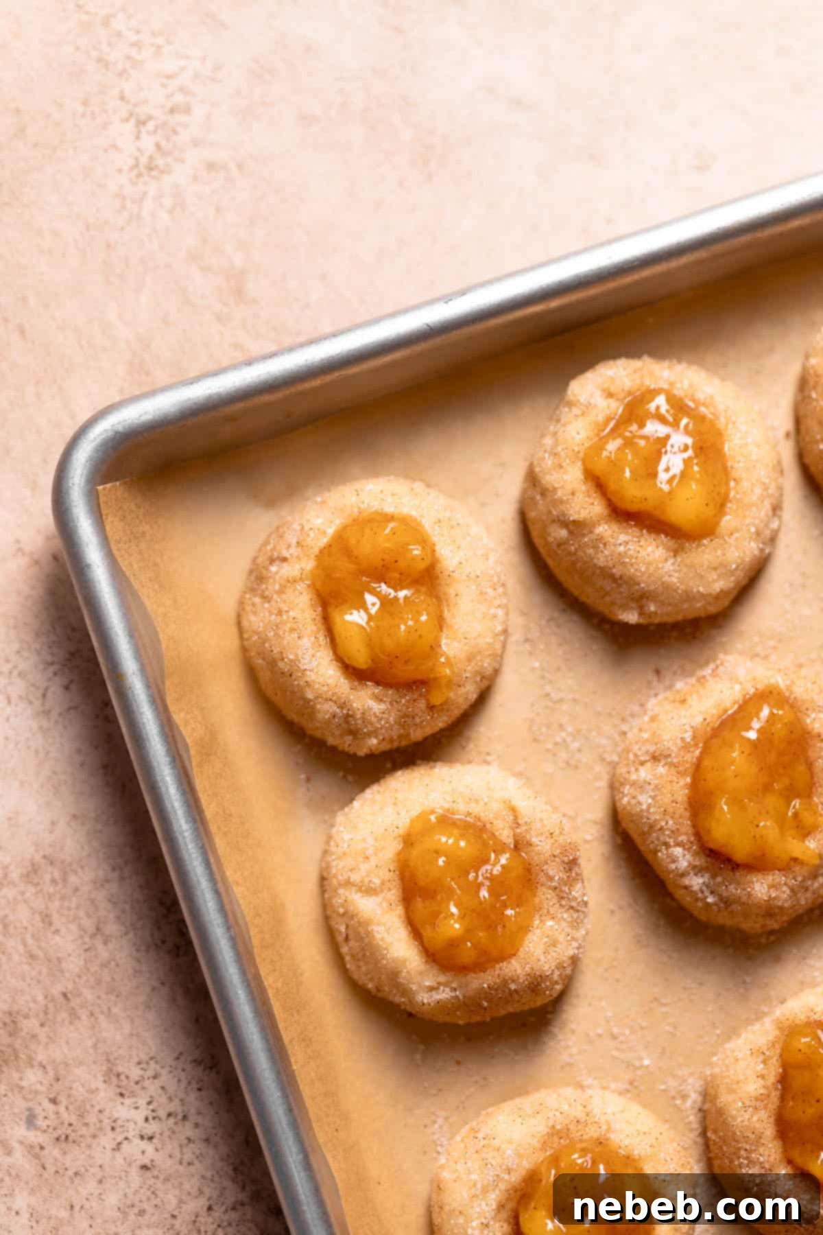 Cookie dough balls with an indentation, ready to be filled with peach cobbler filling.
