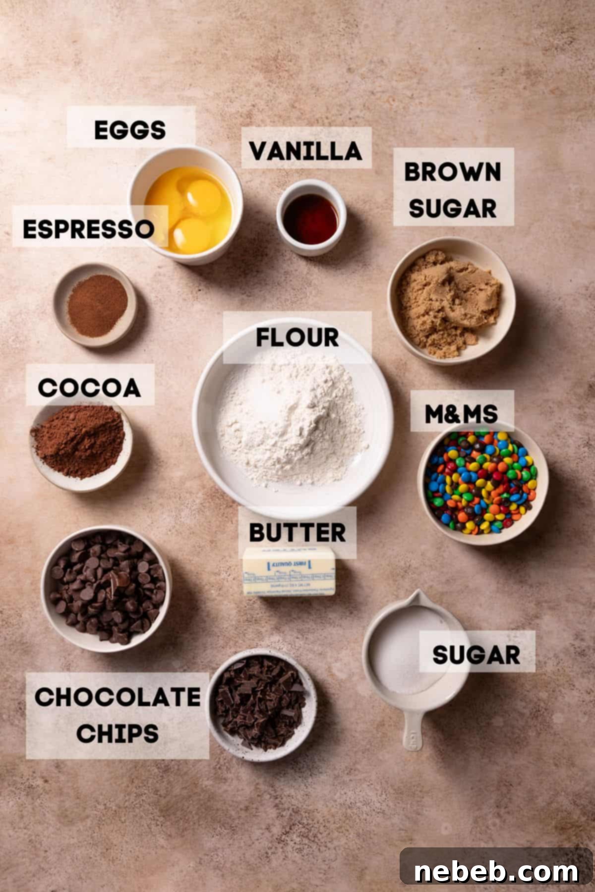 Ingredients needed to make fudgy M&M brownies, neatly arranged in bowls with labels.